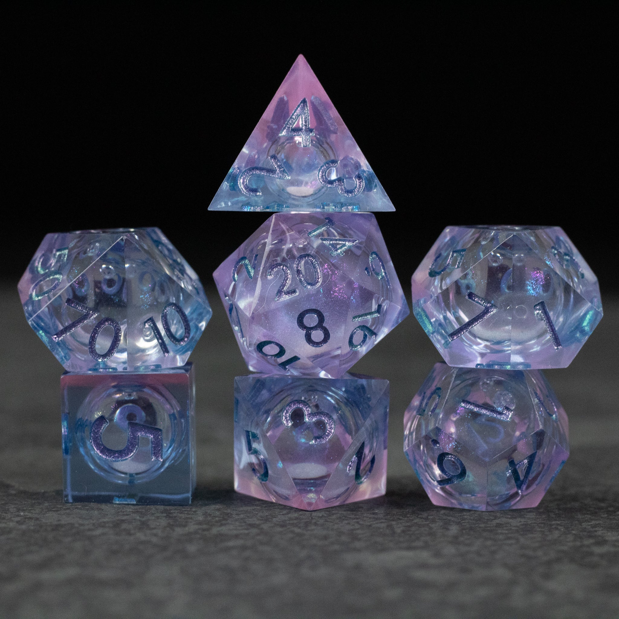 Fae Magic - Liquid Core Dice Set - Translucent purple and blue liquid core polyhedral dice set with black numbering, including d4, d6, d8, d10, d12, and d20.
