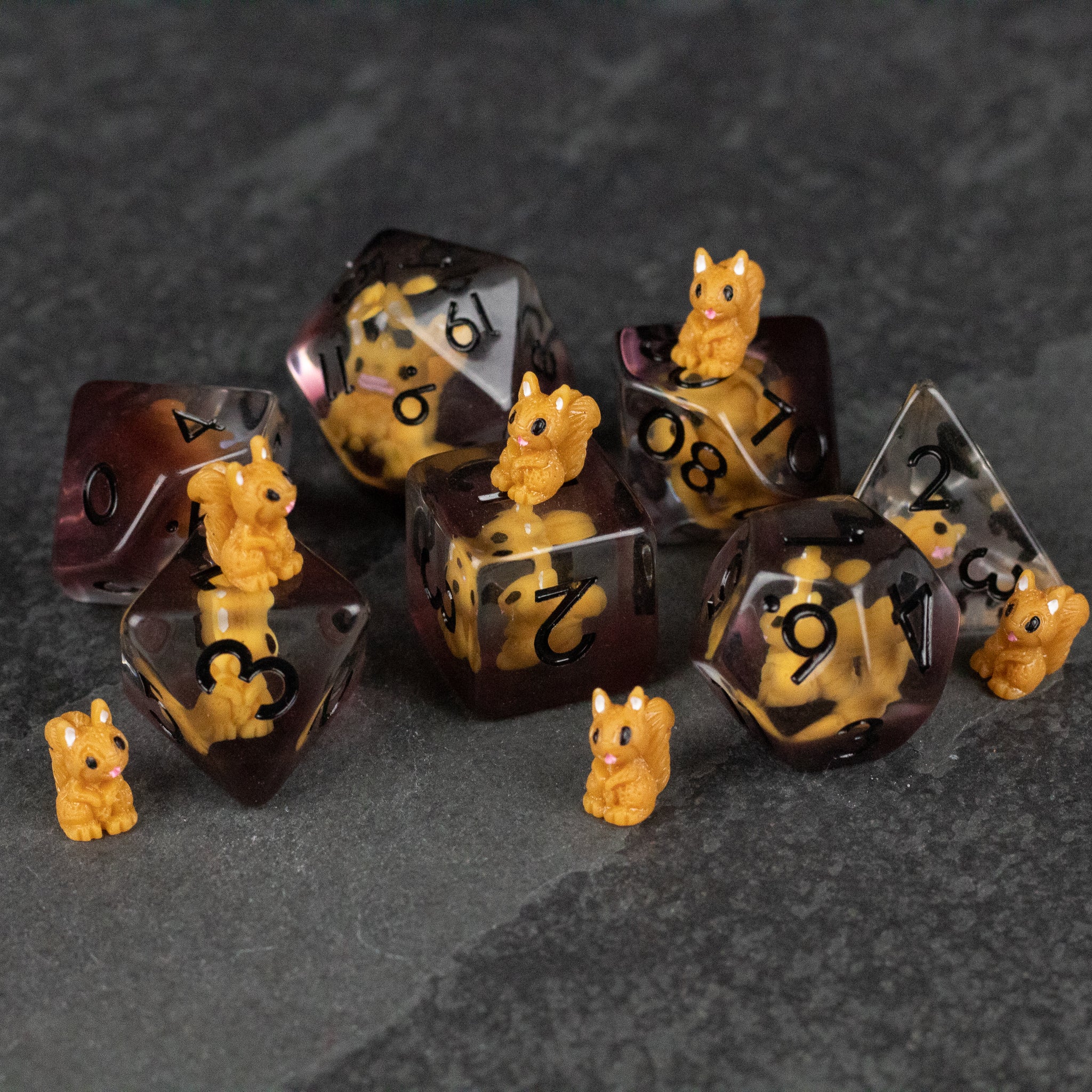 Squirrel Dice Set - Translucent brown polyhedral dice set with black numbers and small detailed yellow squirrel figurines attached and scattered .