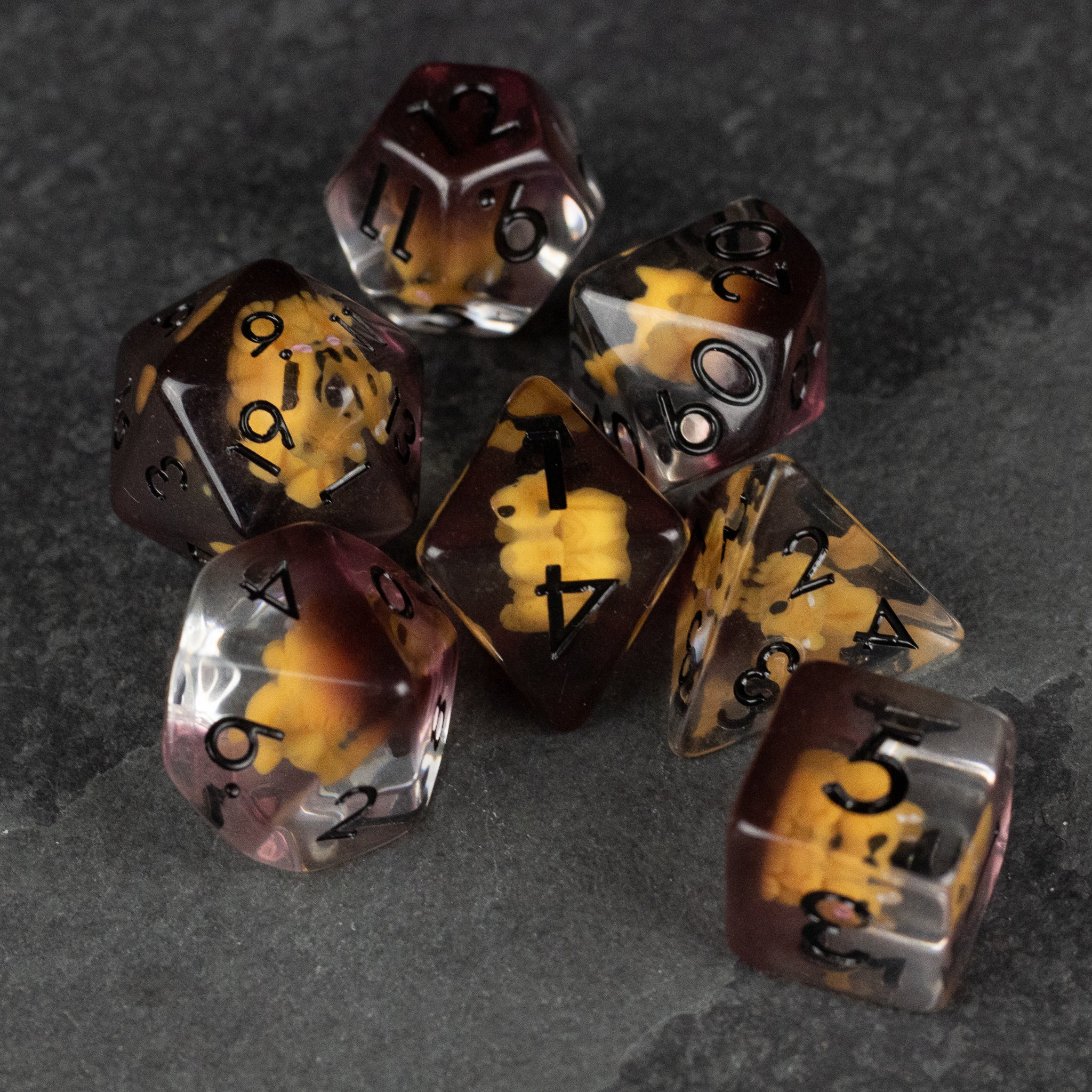 Squirrel Dice Set - Set of seven polyhedral dice in brown, amber, and cream swirls with black numbers, designed for tabletop gaming.