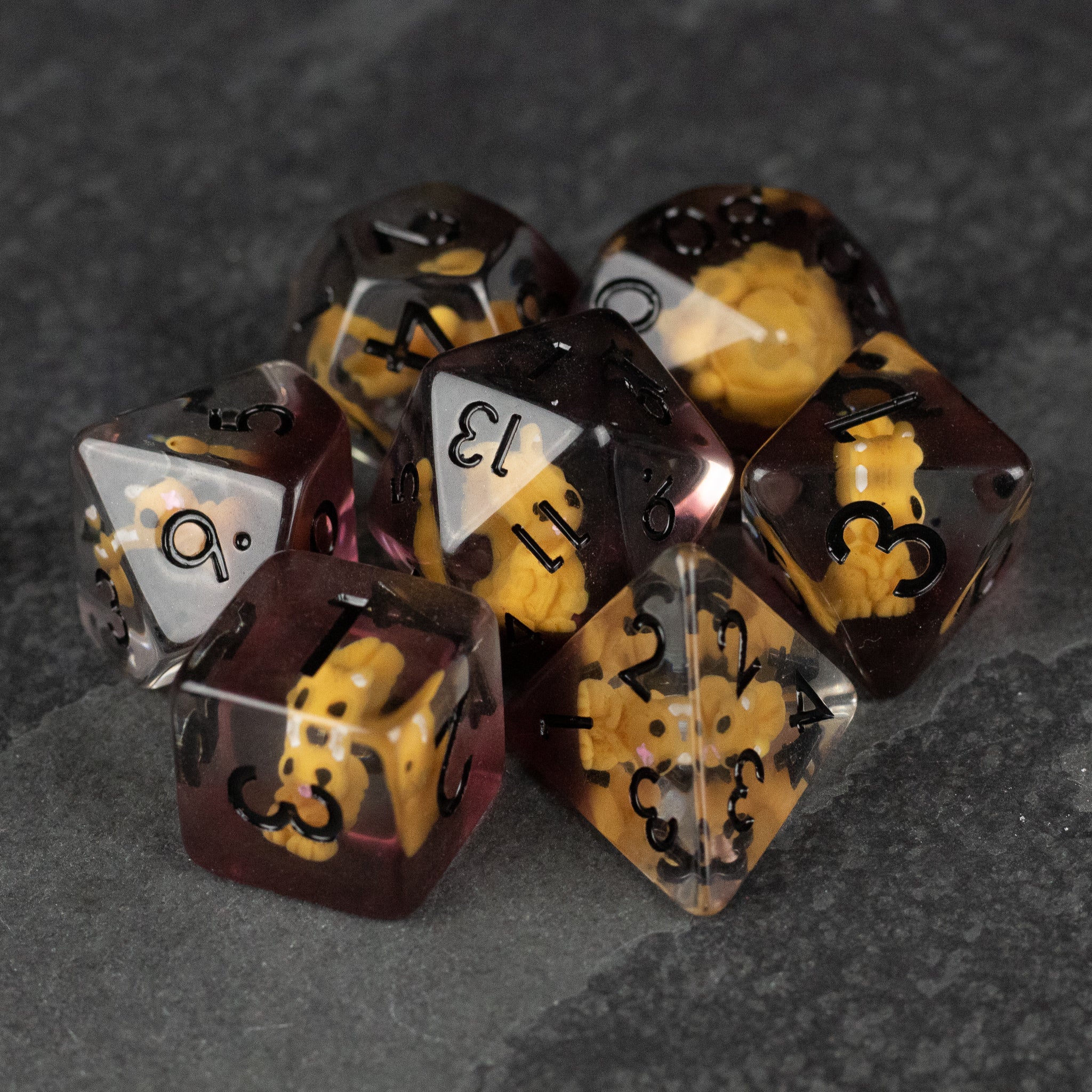 Squirrel Dice Set - Translucent purple polyhedral dice set with embedded yellow squirrel figures and black numbers.