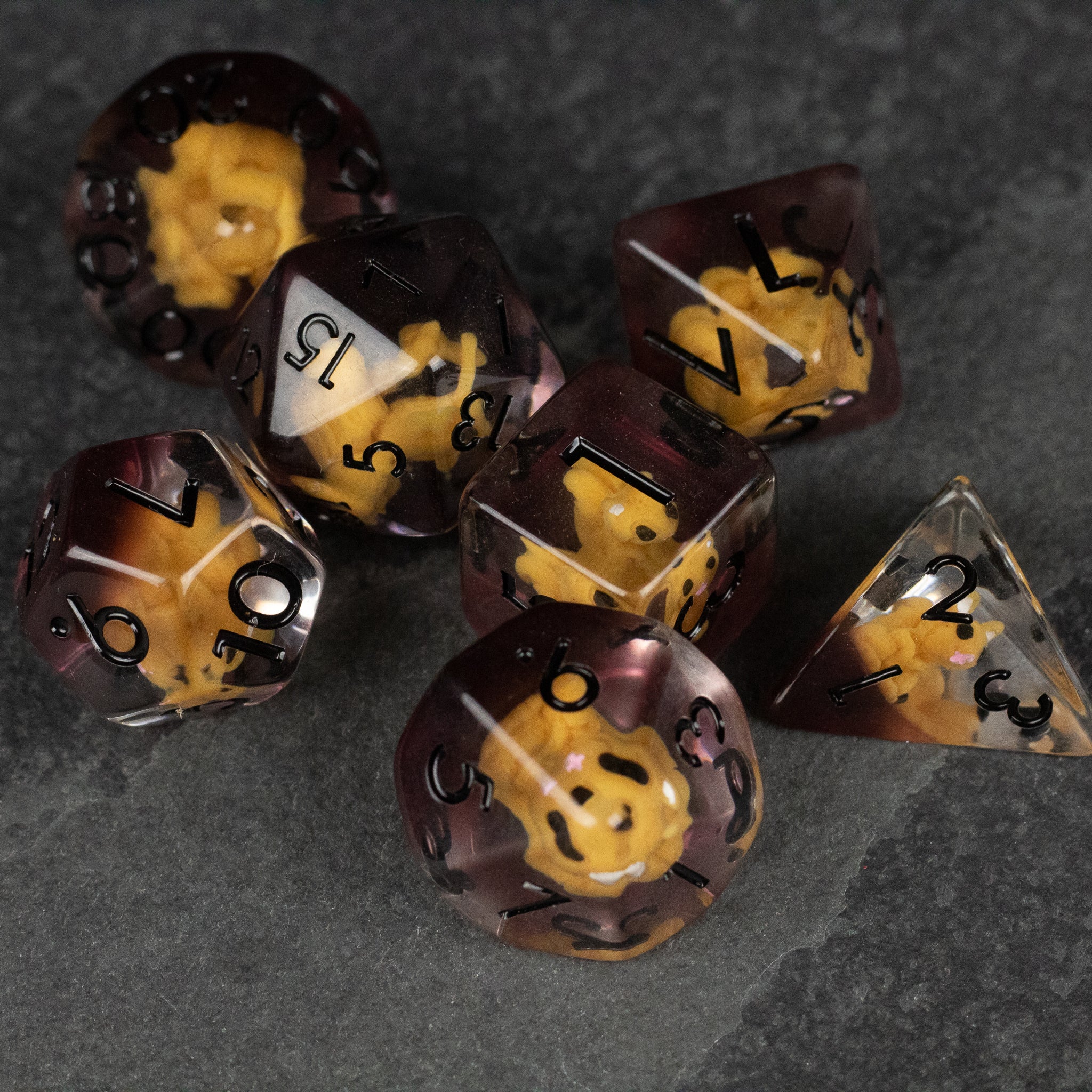 Squirrel Dice Set - Translucent dark brown dice set with yellow squirrel figures inside, black numbers on each die.