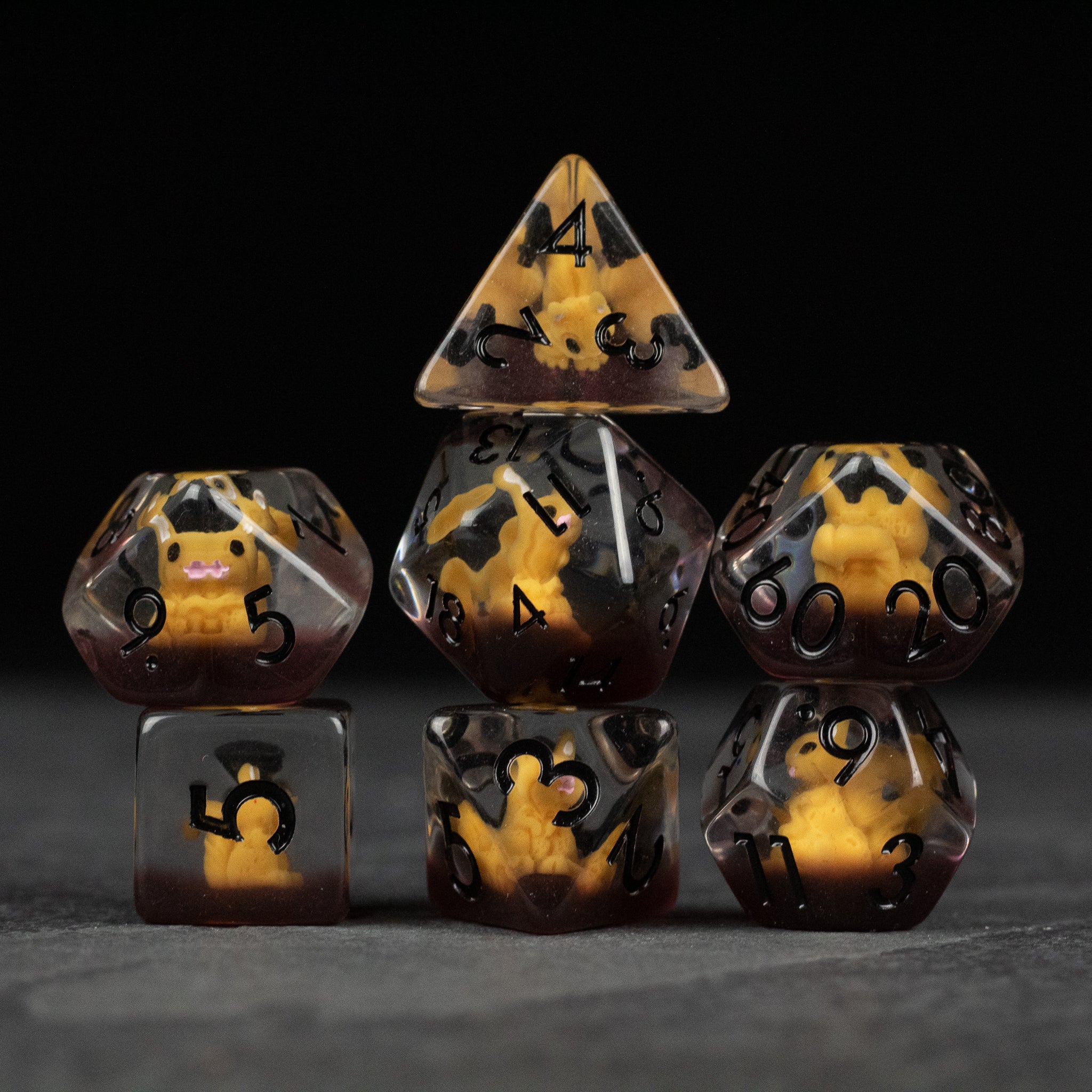 Squirrel Dice Set - Set of seven polyhedral dice in brown and yellow marbled resin with black numbers, featuring a squirrel icon on one die.