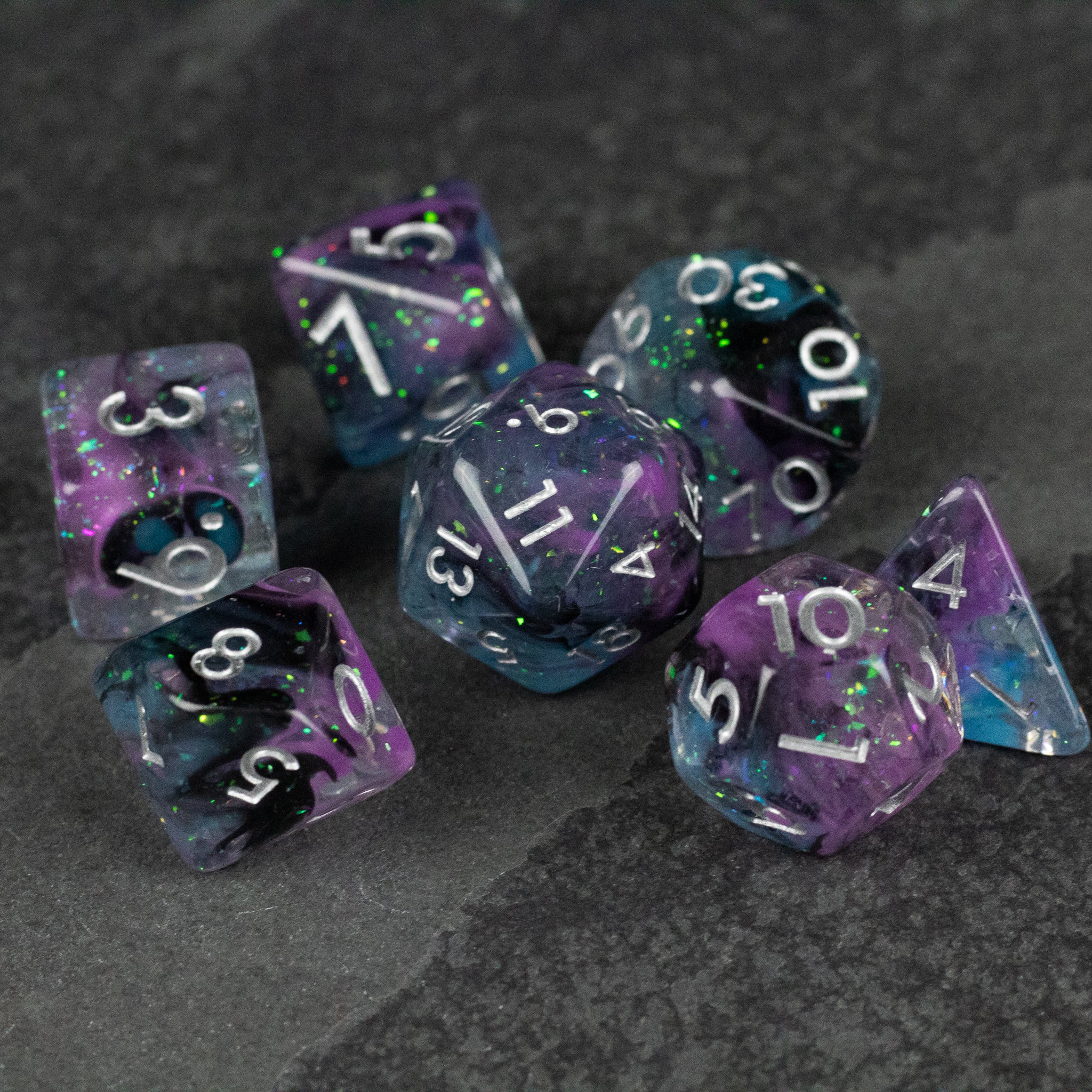 Purple and Black Spellweaver Dice Set - Purple and black marbled seven-piece polyhedral dice set with white numbering.