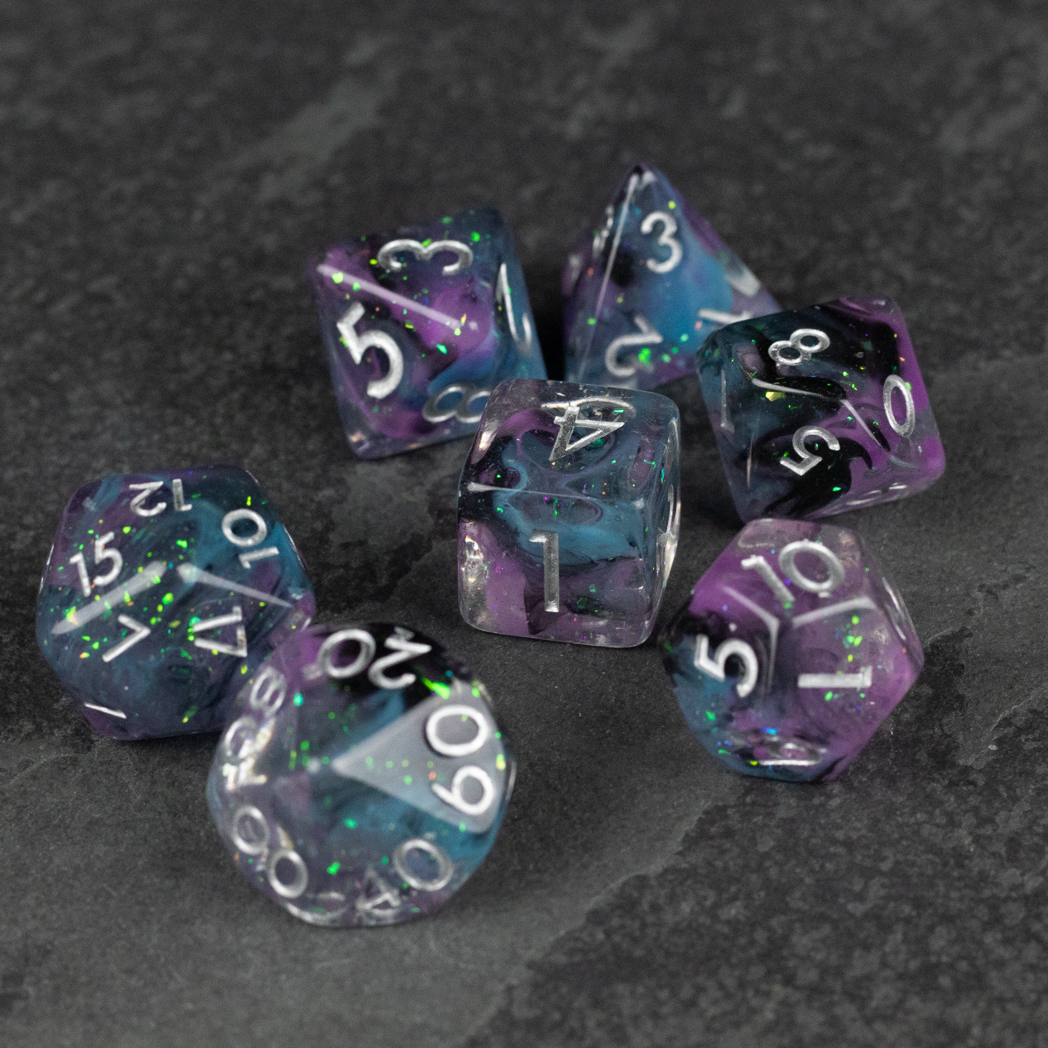 Purple and Black Spellweaver Dice Set - Purple and black marbled gaming dice set with white numbers on a dark surface.