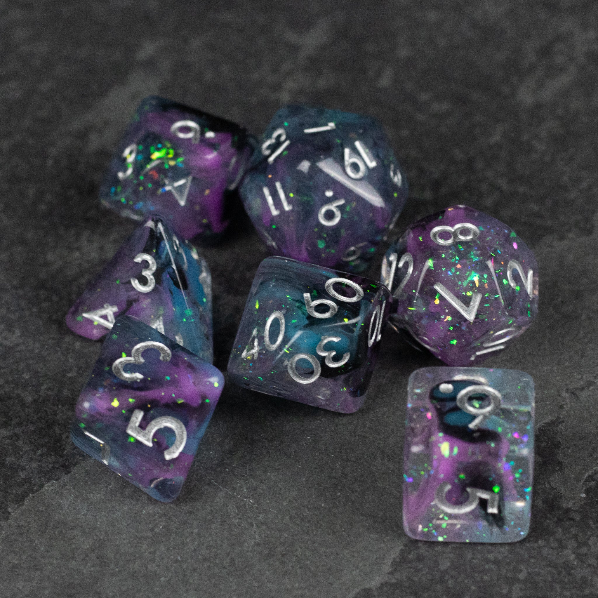 Purple and Black Spellweaver Dice Set - Purple and black marbled dice set with white numbers, including various polyhedral shapes for tabletop gaming.