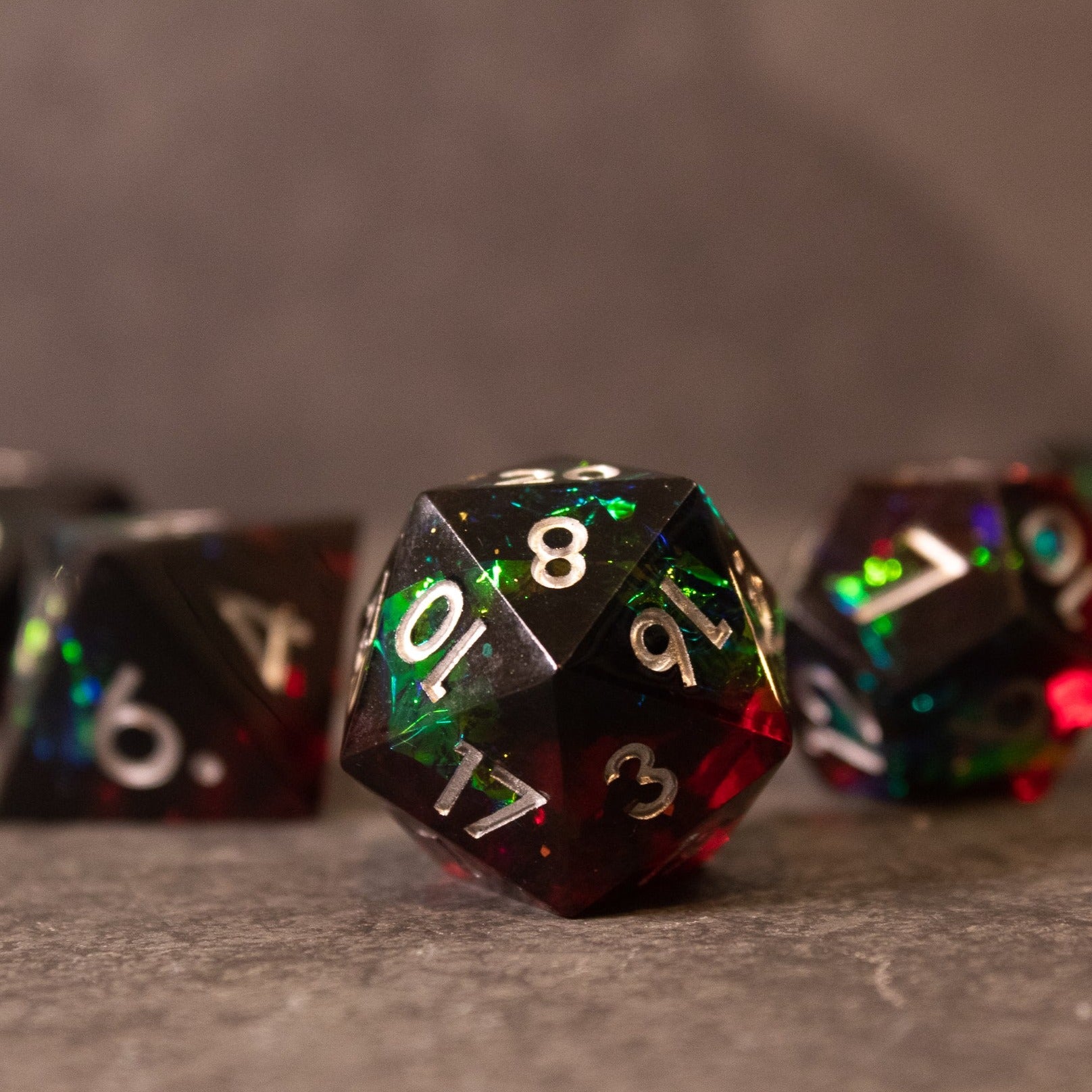 Blood Magic - Sharp Edge Opalescent Dice - Black and red sharp edge 20-sided dice with opalescent shimmer and white numbers.