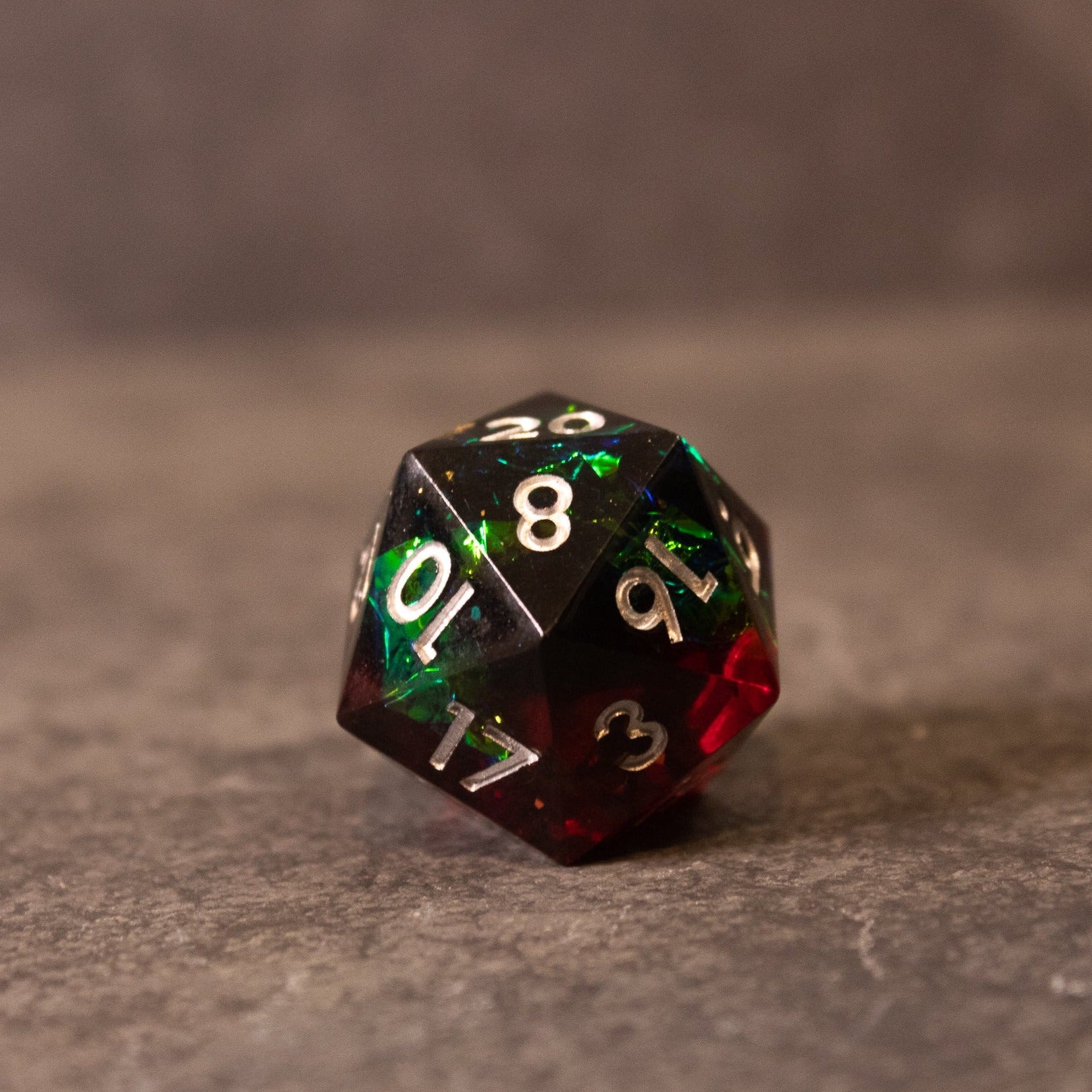 Blood Magic - Sharp Edge Opalescent Dice - Sharp edge 20-sided dice with opalescent black, red, and green colors and white numbering.