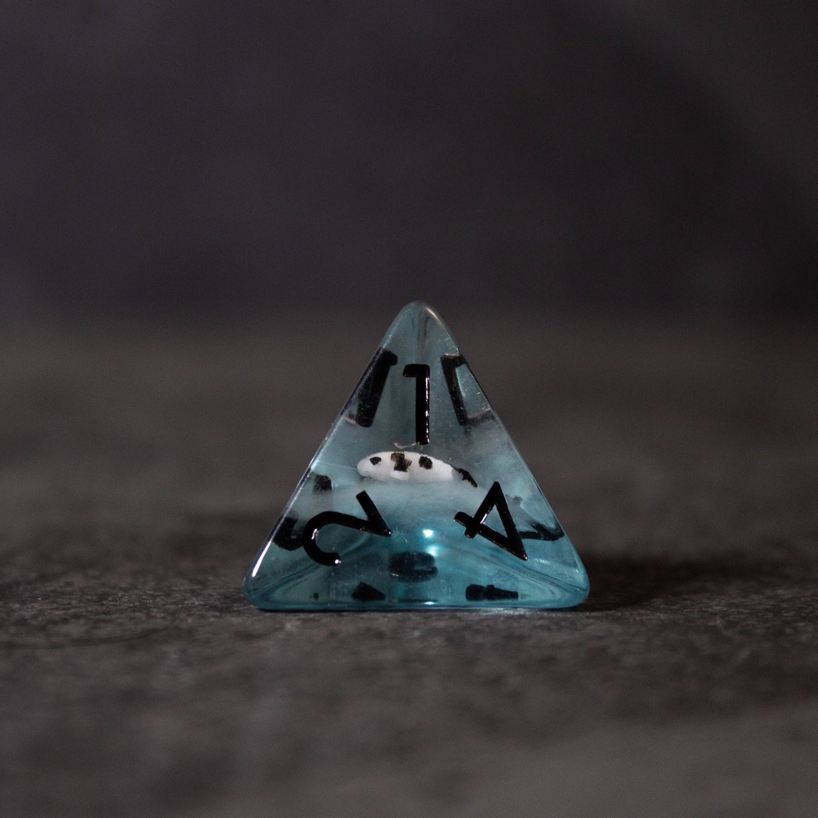 Black Koi & Steel Blue Dice - Transparent steel blue four-sided die with black numbers and a small black koi fish inside.
