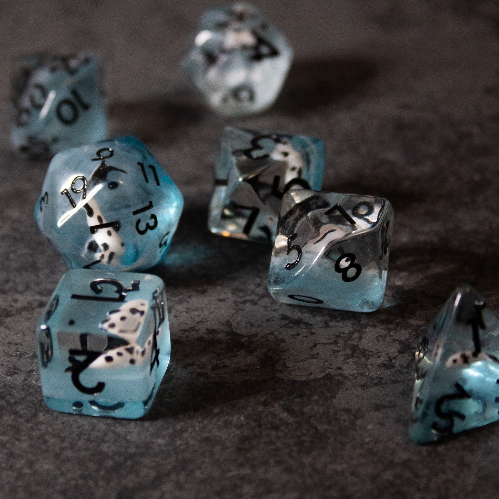 Black Koi & Steel Blue Dice - Translucent steel blue polyhedral dice set with black koi fish inclusions and black numbering.
