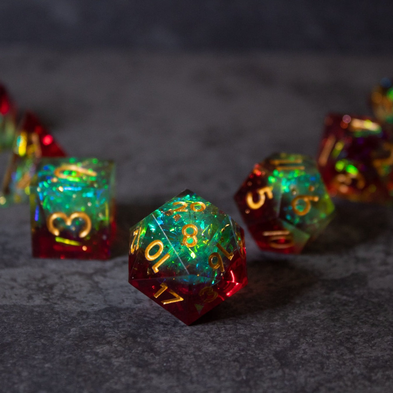 Fairy Fire - Sharp Edge Opalescent Dice - Opalescent sharp-edged d20 dice with glowing green and red colors and gold numbers.