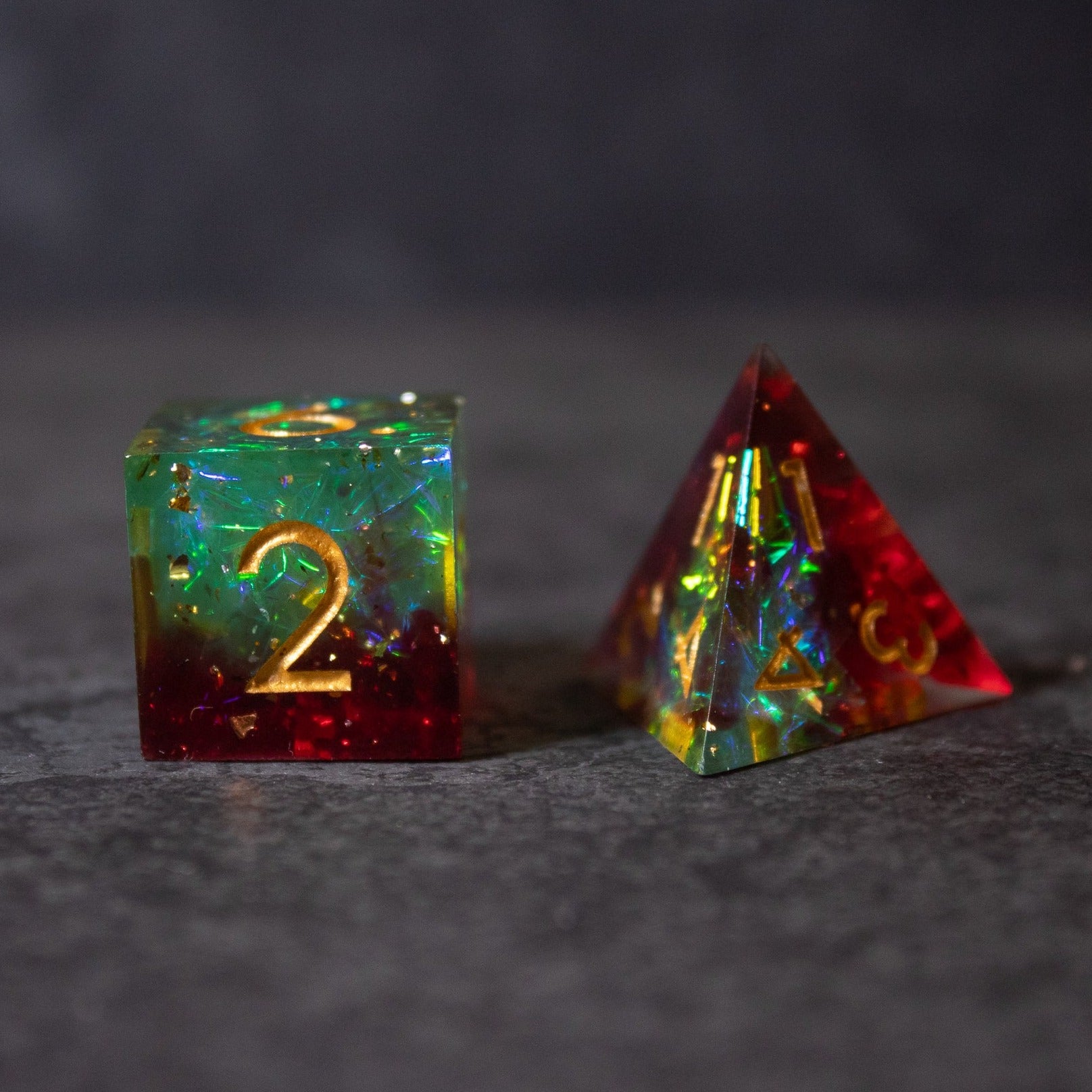 Fairy Fire - Sharp Edge Opalescent Dice - Opalescent sharp edge dice with fiery red base and sparkling green-blue upper half, gold numbers.