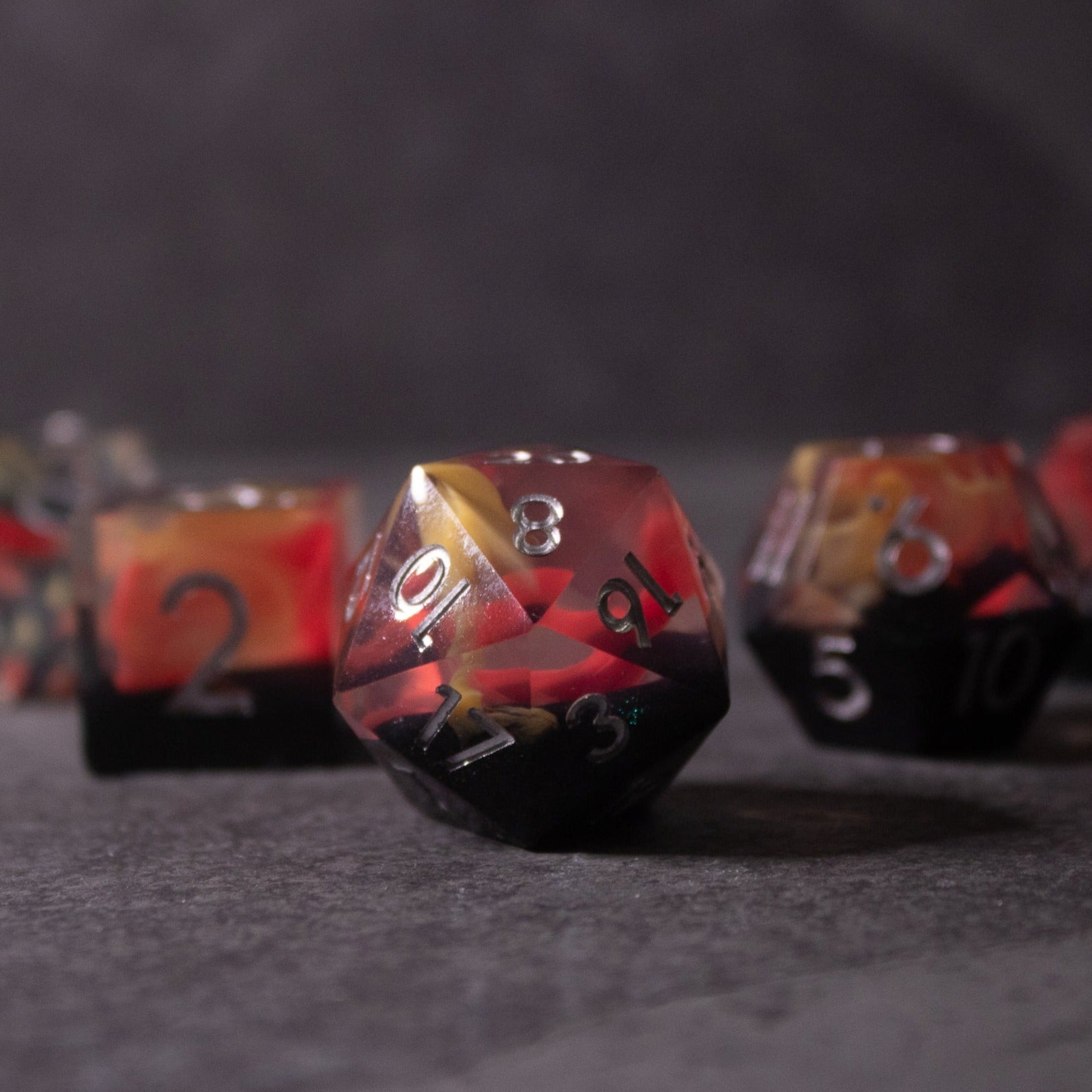 Widowgast's Flame - Sharp Edge Dice - Red and black d20 sharp edge dice with white numbering and fiery gradient design.