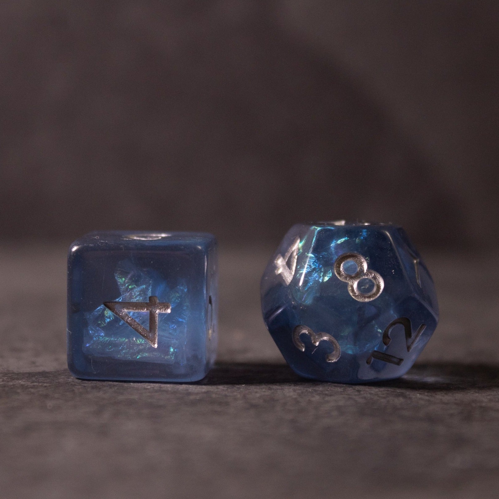 Glacier Ice Dice Set - Blue translucent dice set with silver rings inside, featuring a cube and a d20 die.