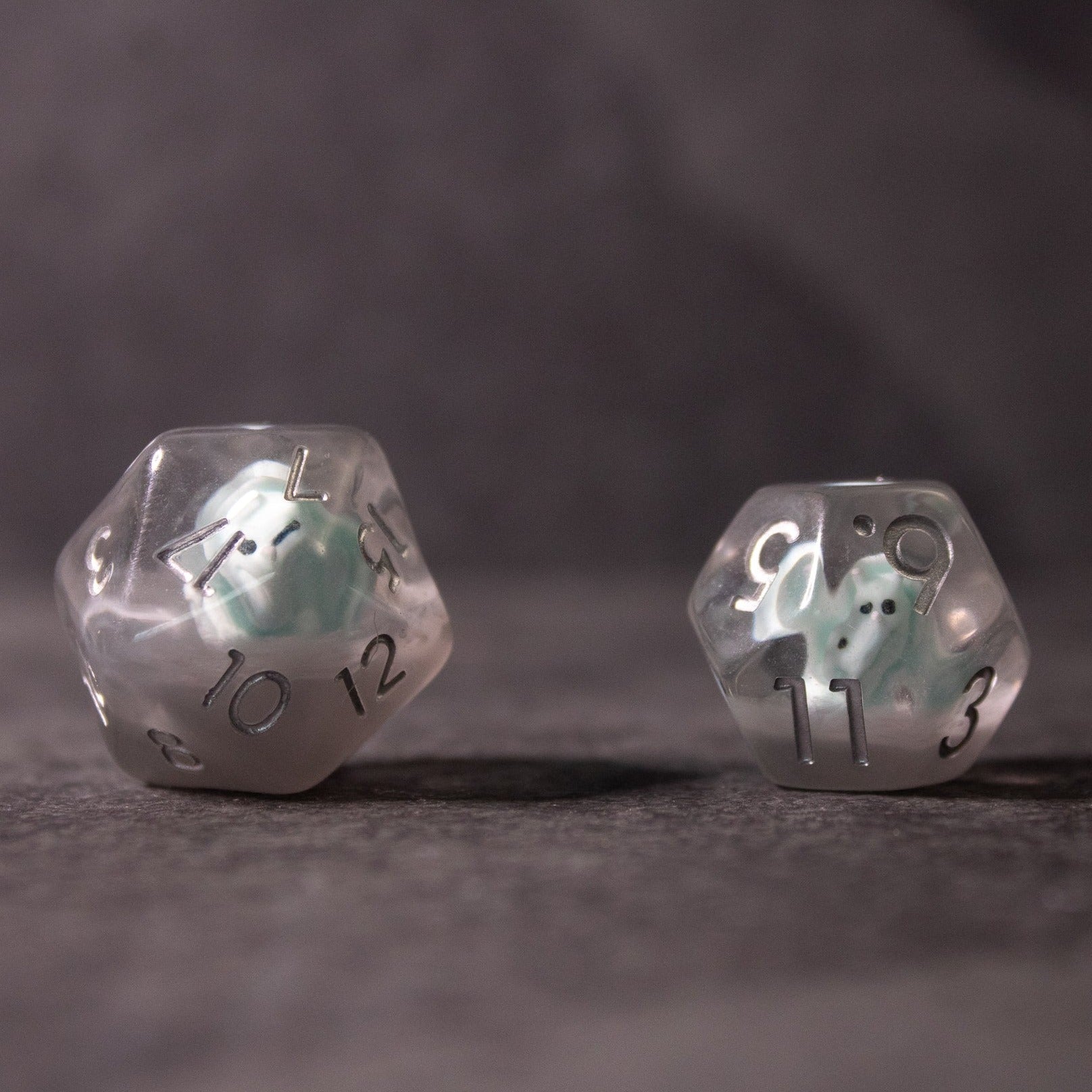 Dinosaur Dice Set - Triceratops - Clear plastic 12-sided and 10-sided dice with mint green triceratops figures inside.