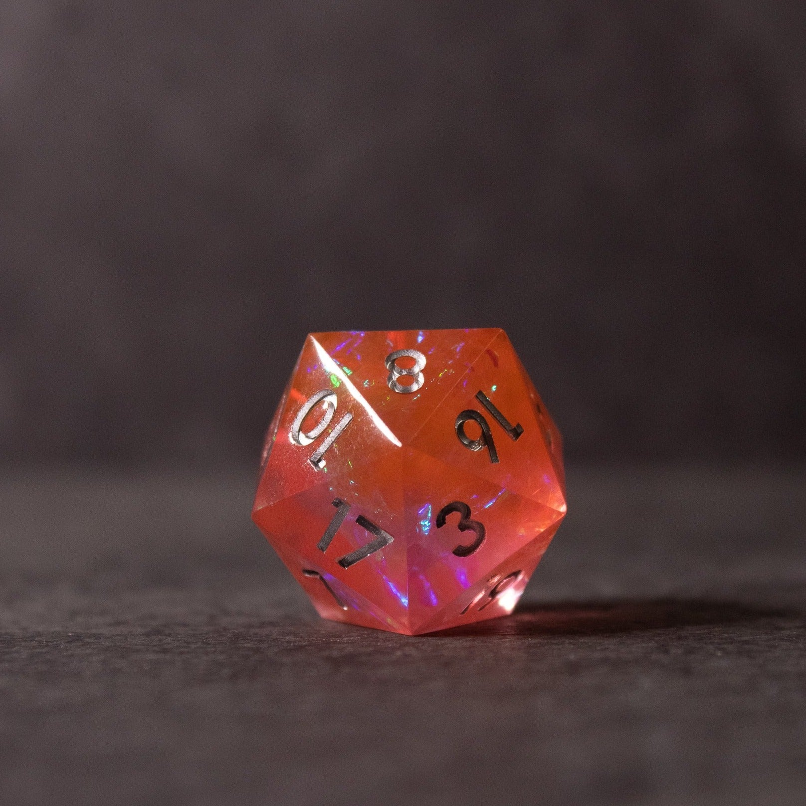 Heart Fire - Opalescent Sharp Edge Dice Set - Red opalescent sharp-edged 20-sided dice with black numbering and iridescent flashes.