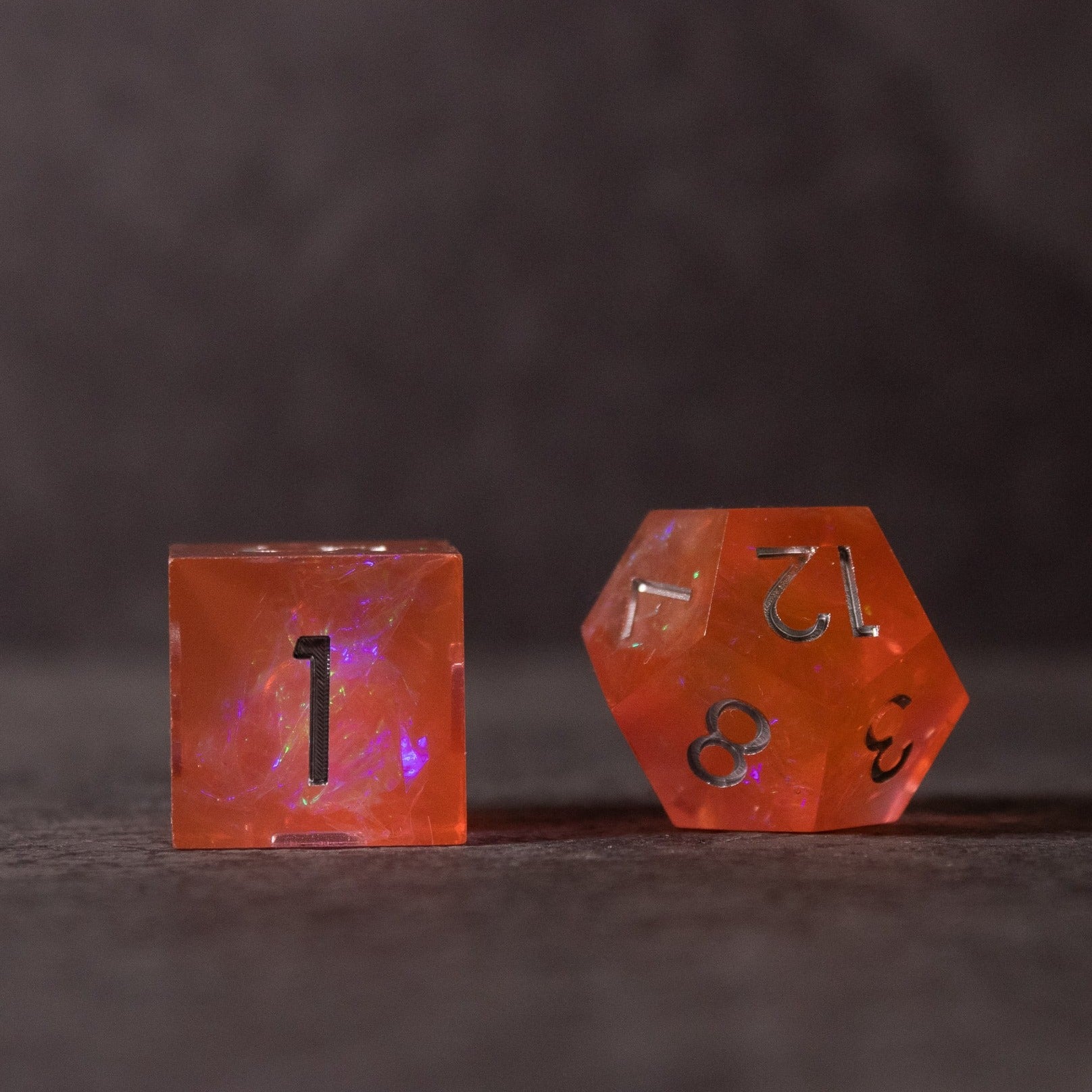 Heart Fire - Opalescent Sharp Edge Dice Set - Opalescent orange sharp-edge dice set with black numbering, featuring a cube and a d12 shape.