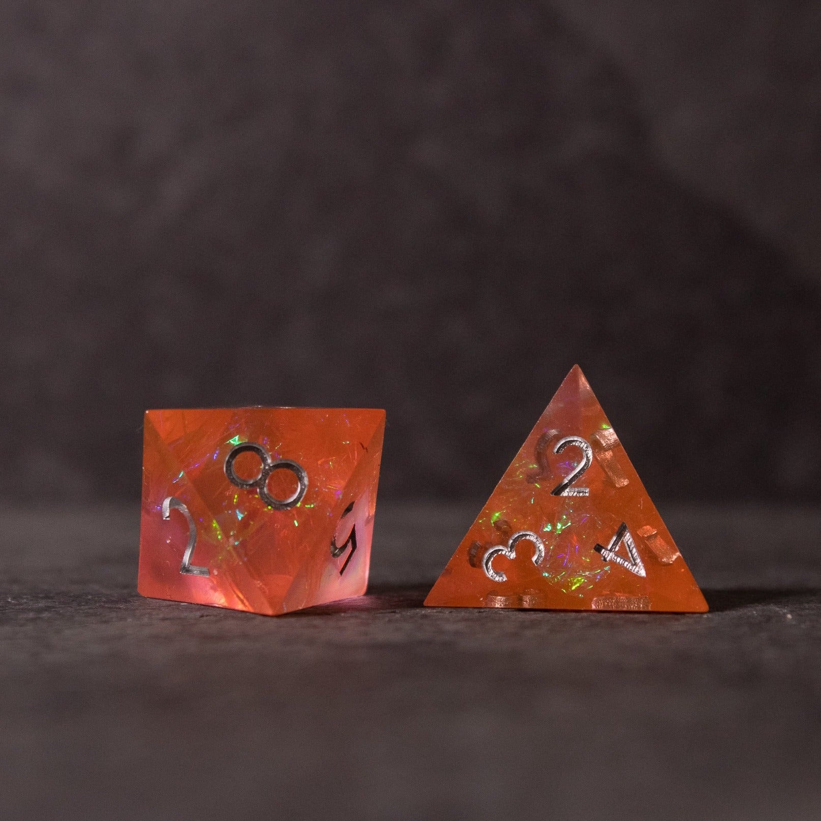 Heart Fire - Opalescent Sharp Edge Dice Set - Orange opalescent sharp-edge dice set featuring multifaceted d20 and four-sided d4 with white numbering.