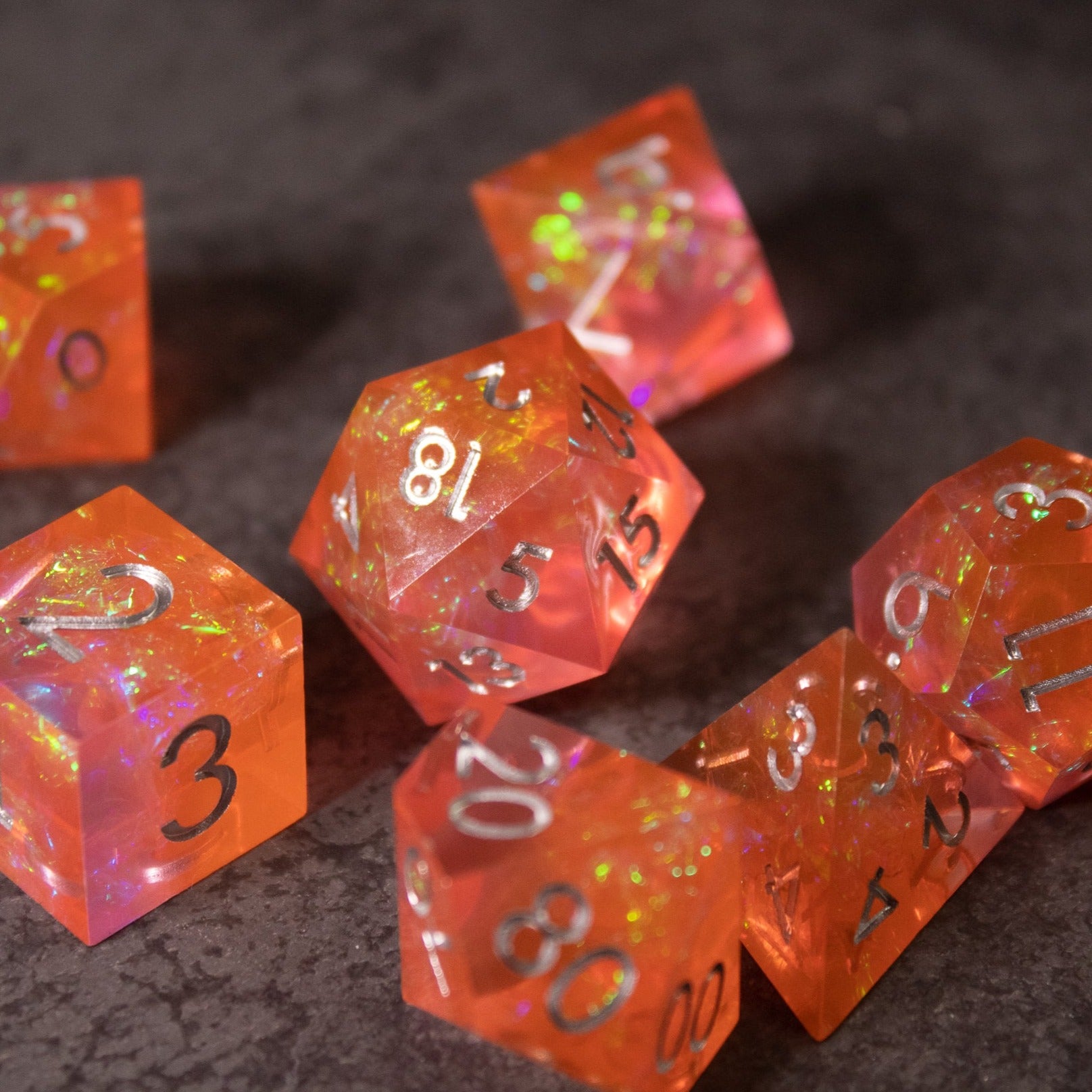 Heart Fire - Opalescent Sharp Edge Dice Set - Opaque red-orange sharp-edged dice set with opalescent glitter and white numbering.