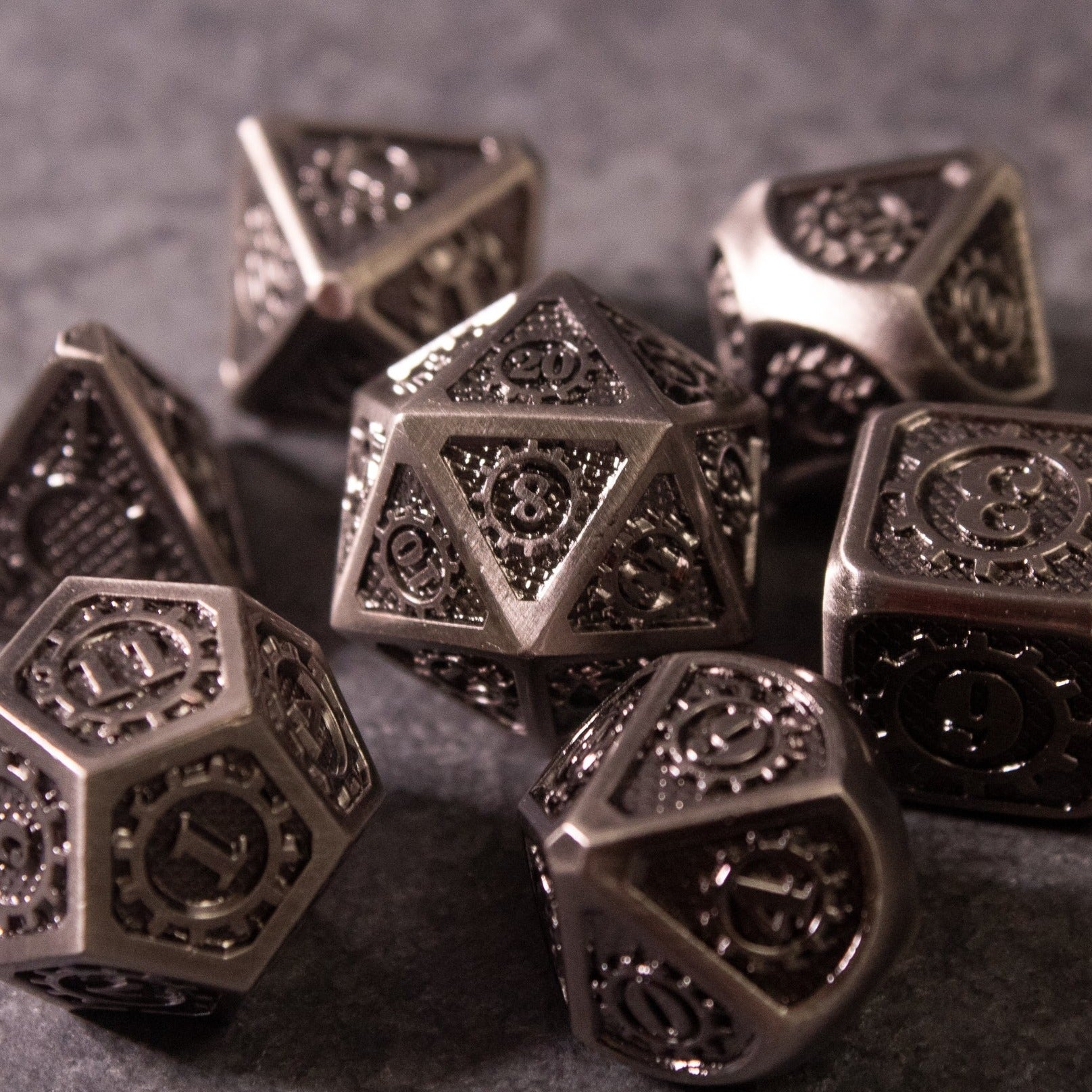 Metal Gear Dice Set - Silver metal polyhedral dice set with intricate gear and mechanical engravings.