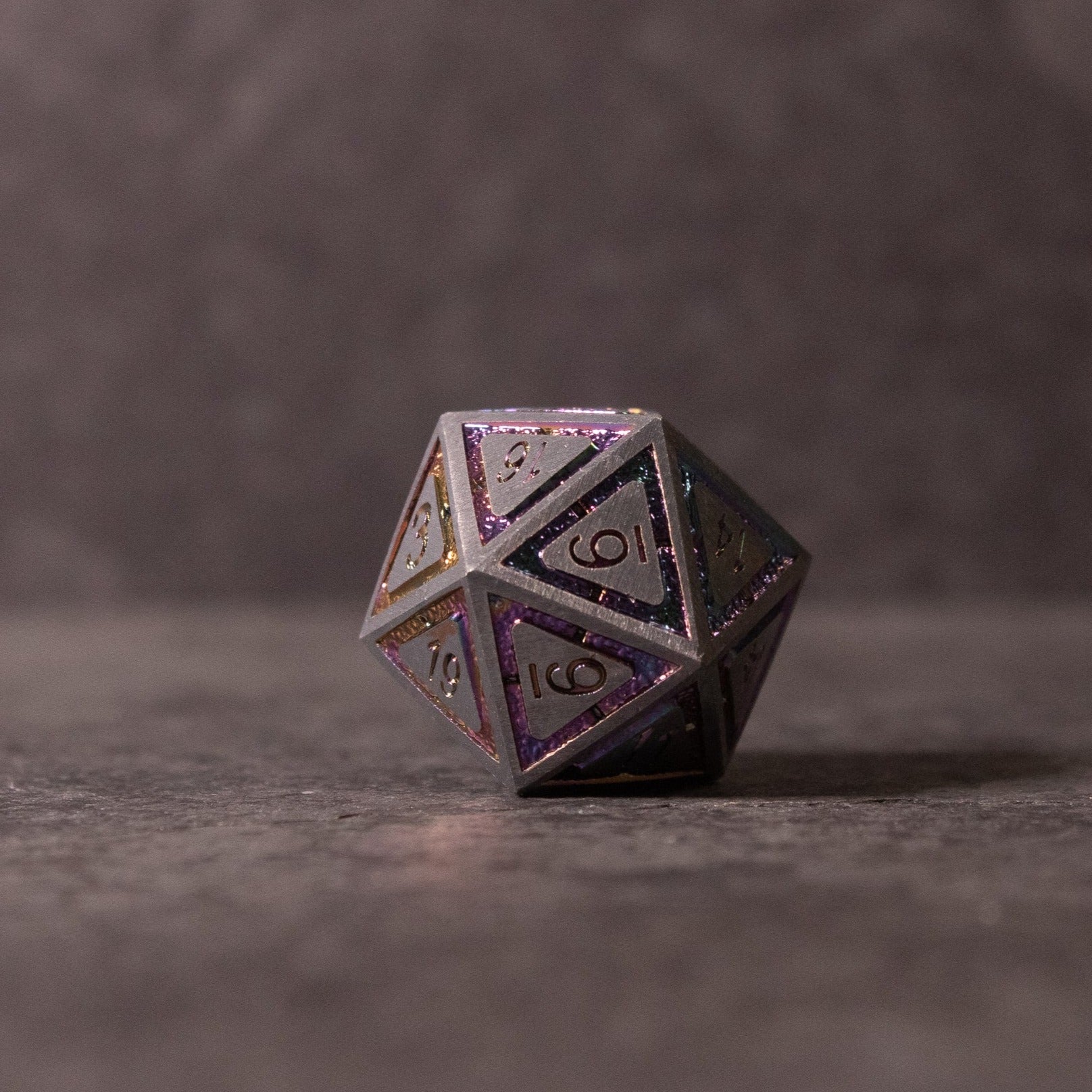 Prismatic Core Dice Set - Metallic black 20-sided dice with purple glitter accents and engraved numbers.