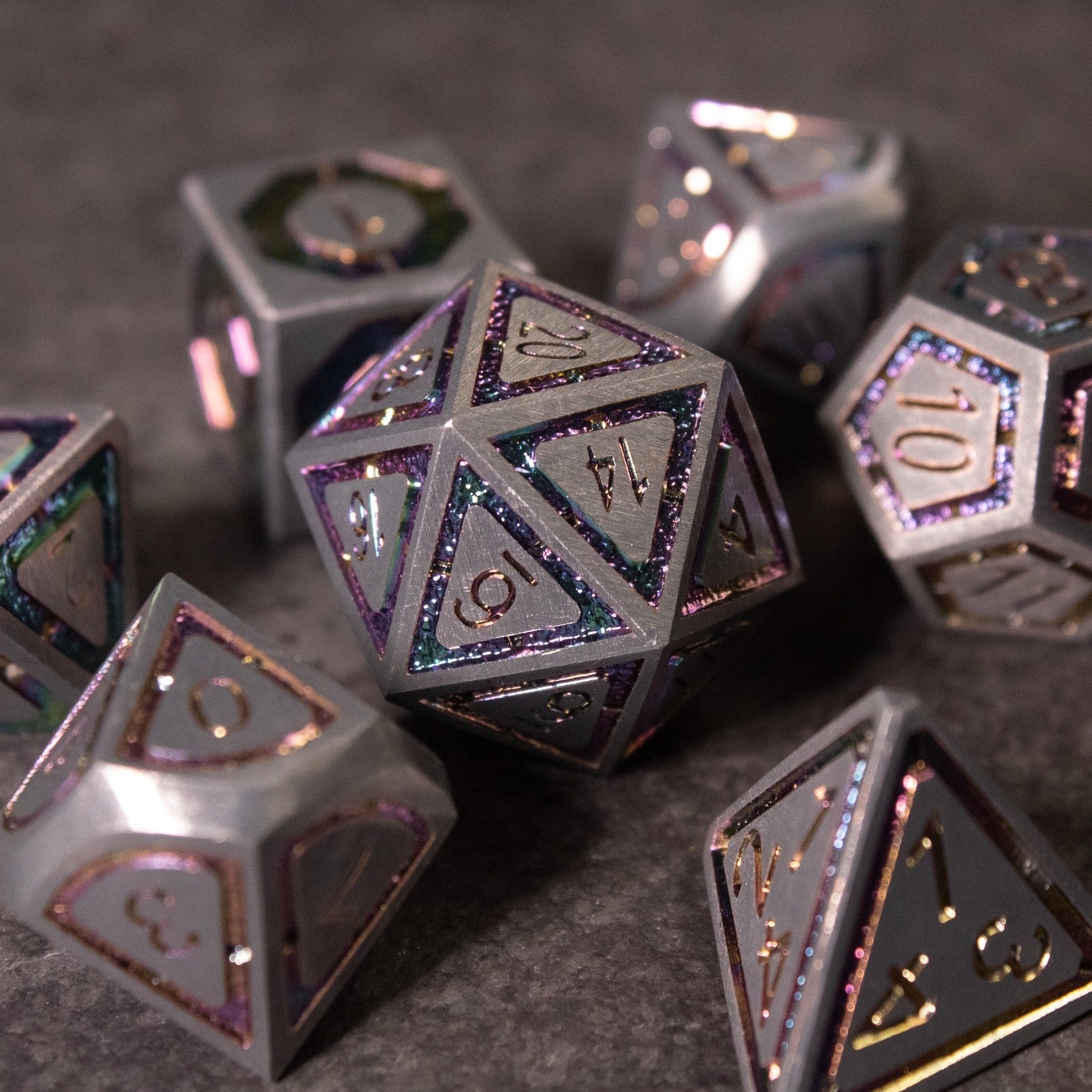Prismatic Core Dice Set - Metallic polyhedral dice set with a prismatic finish, including d20, d12, d10, d8, d6, and d4, featuring etched numbers.