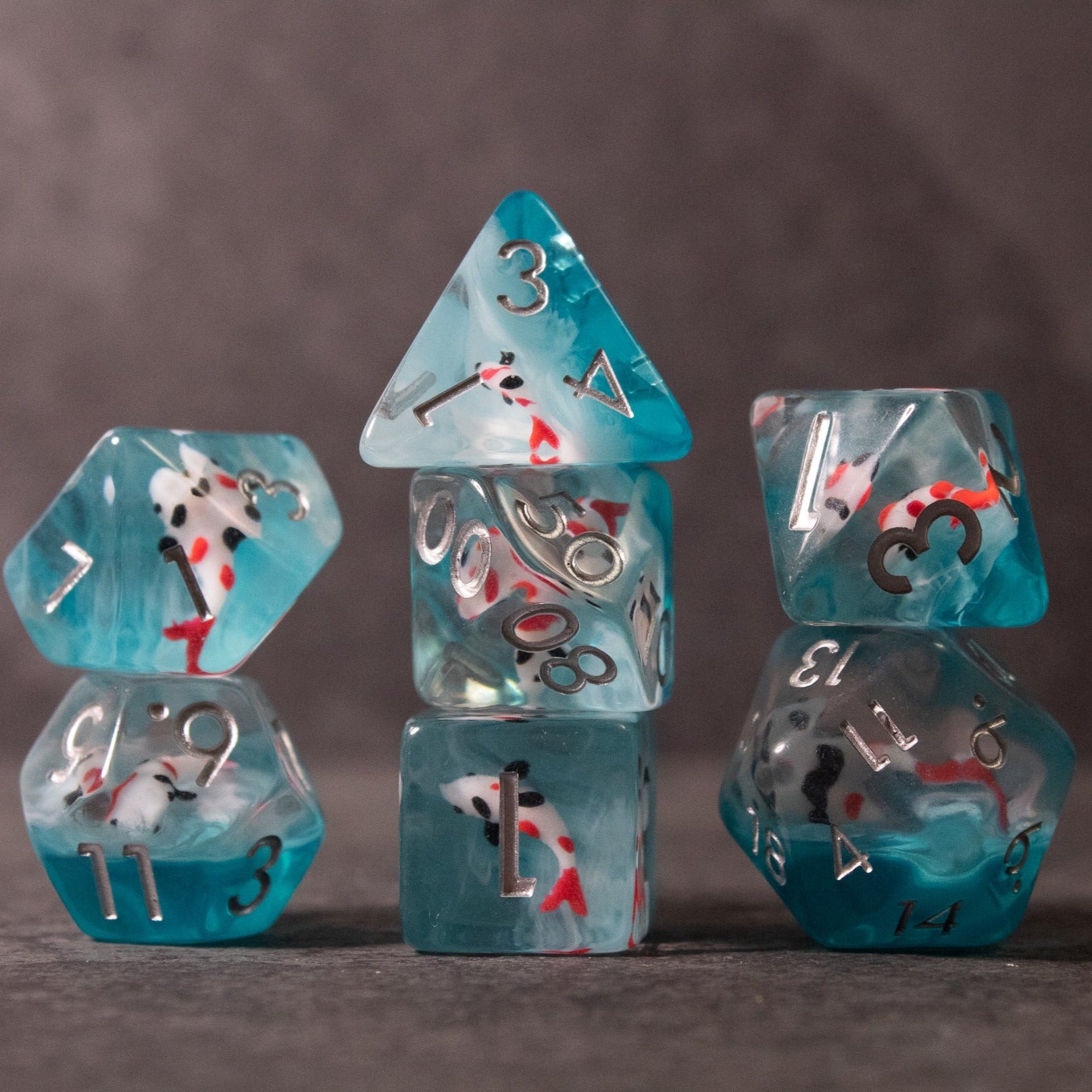 Koi Fish Dice Set - Transparent turquoise Koi fish themed six-piece dice set with white and red koi designs and silver numbers.