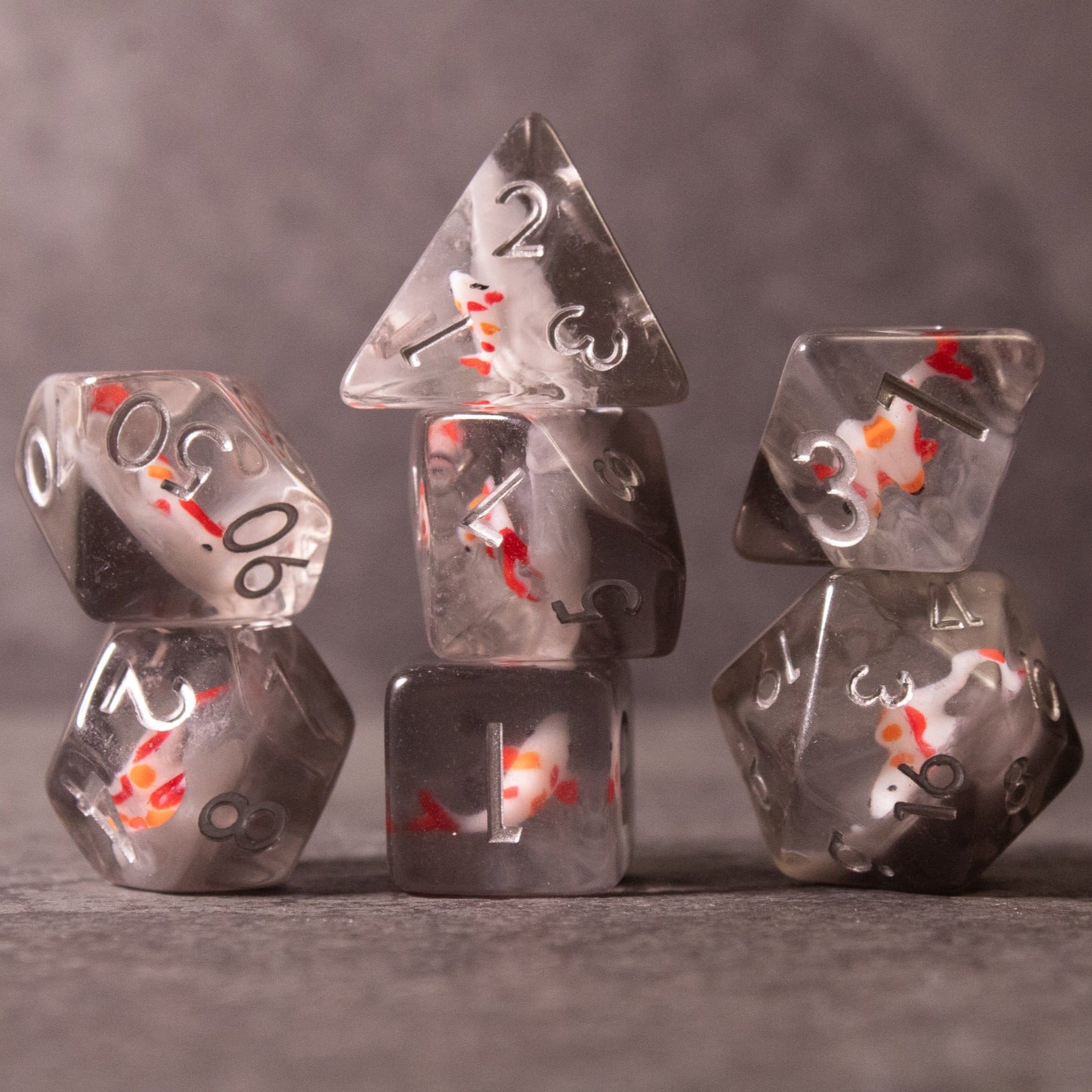 Koi Fish Dice Set - Transparent polyhedral dice set with miniature koi fish inside and white numbers.