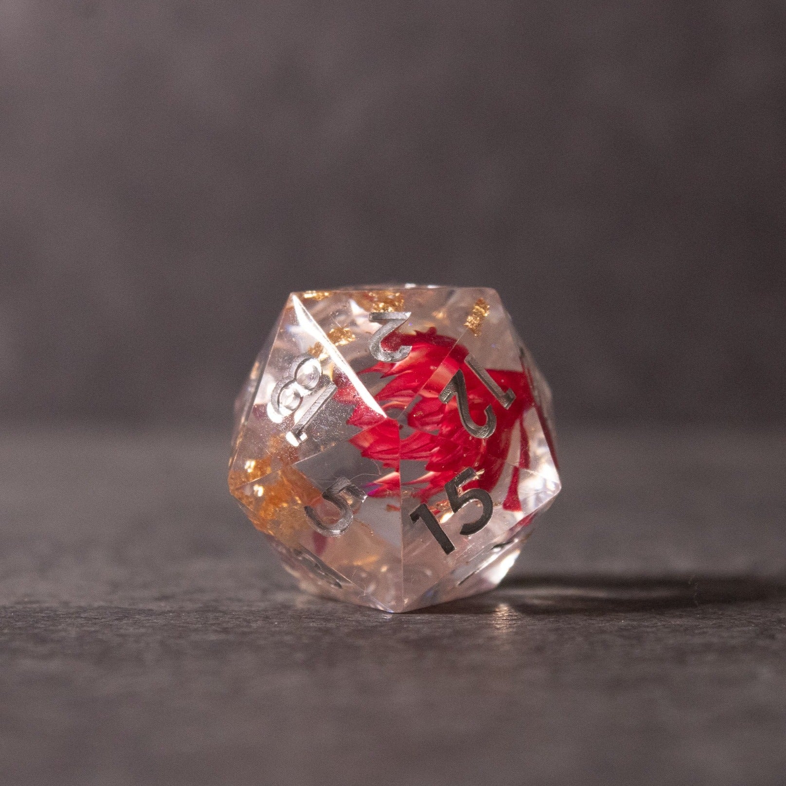 Red Lotus Flower Dice Set - Clear 20-sided dice with sharp edges featuring a red lotus flower design inside and black numbering.