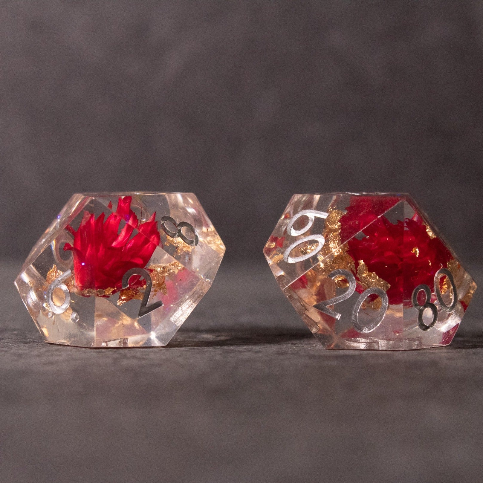 Red Lotus Flower Dice Set - Clear resin sharp-edged d20 dice with red lotus flower embedded inside, gold numbers.