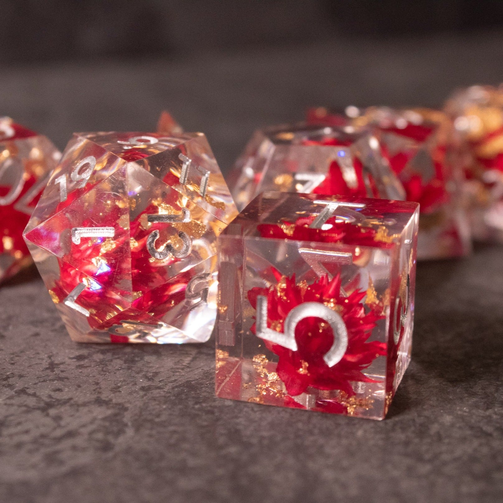 Red Lotus Flower Dice Set - Clear acrylic dice set with sharp edges, embedded red lotus flower petals, and red numbers.