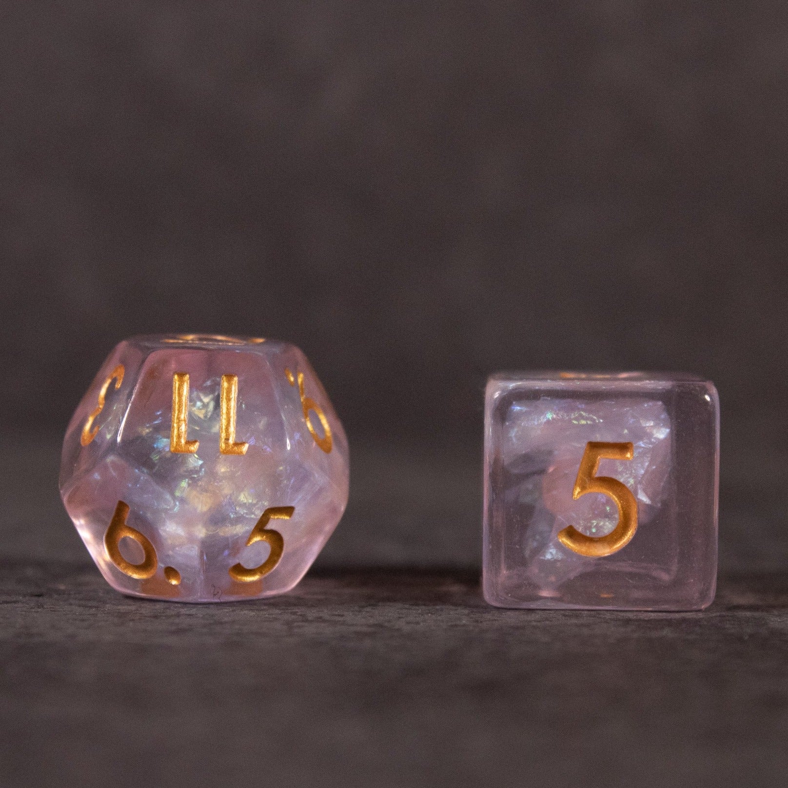 Sakura Dice Set - Iridescent pink 20-sided and 6-sided dice with gold numbering and embedded inclusions.