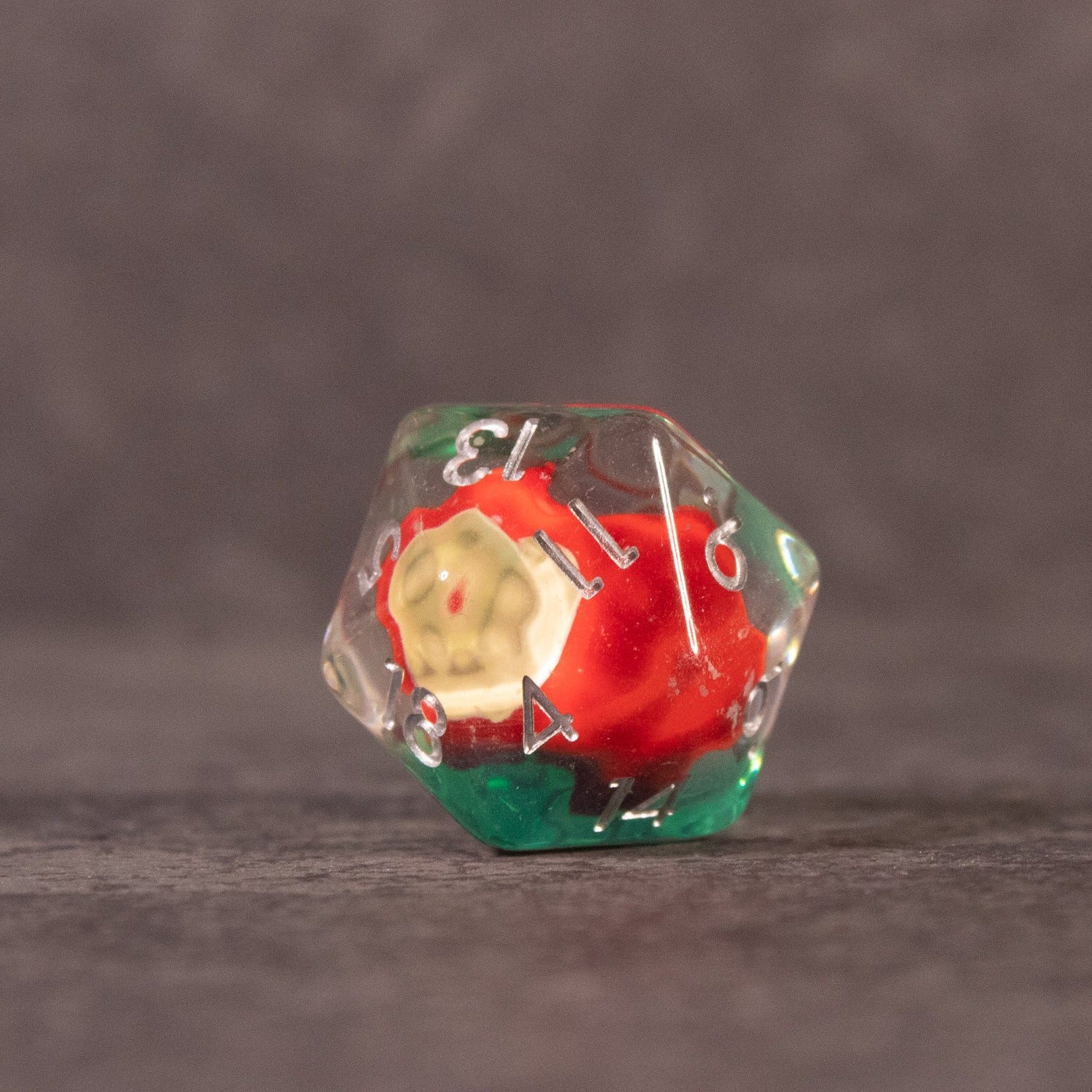 Apple Bite Dice Set - Clear 20-sided dice with a miniature red apple and green leaves embedded inside, white numbers on each face.