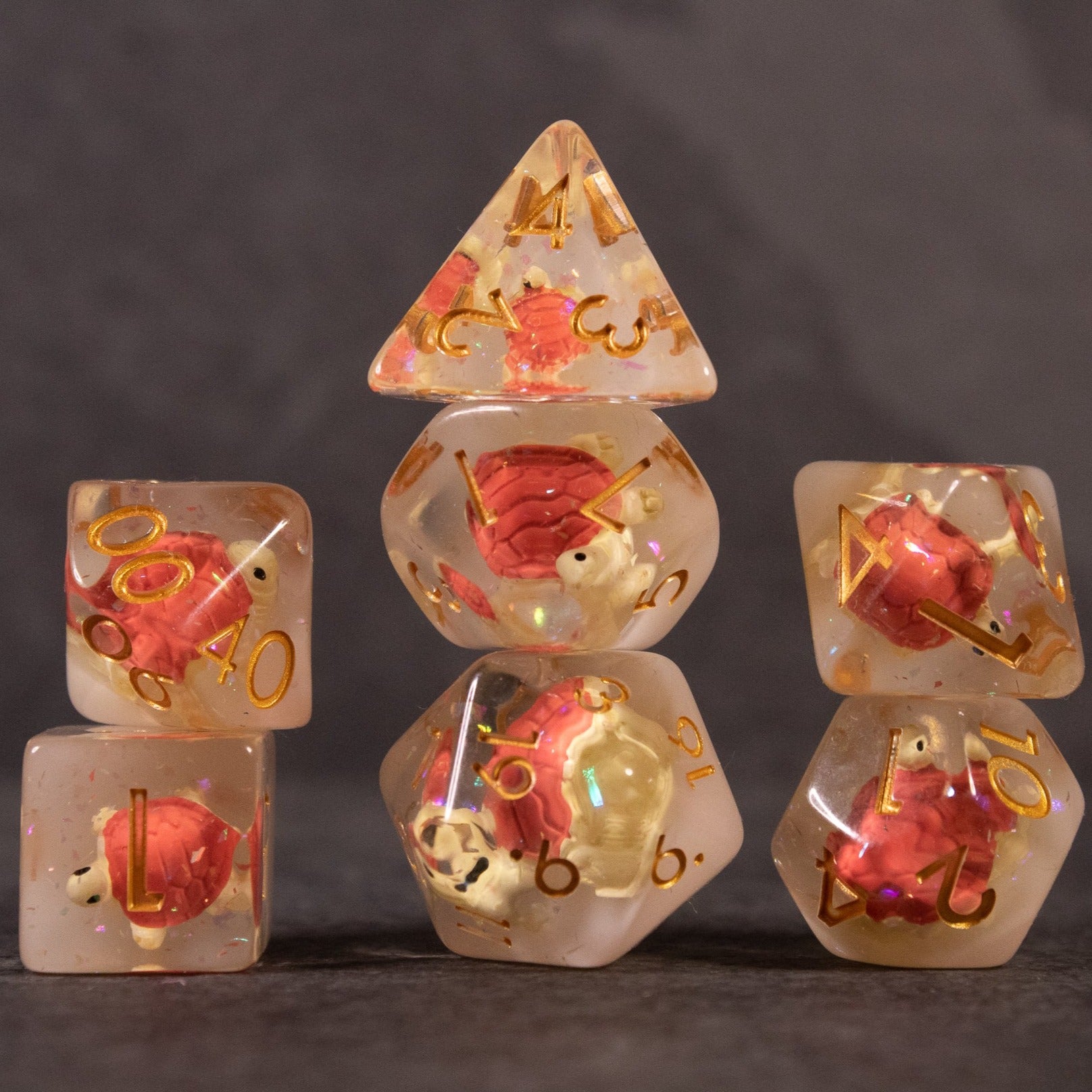 Brown Turtle Dice Set - Transparent brown polyhedral dice set with embedded miniature turtles and gold numbering.