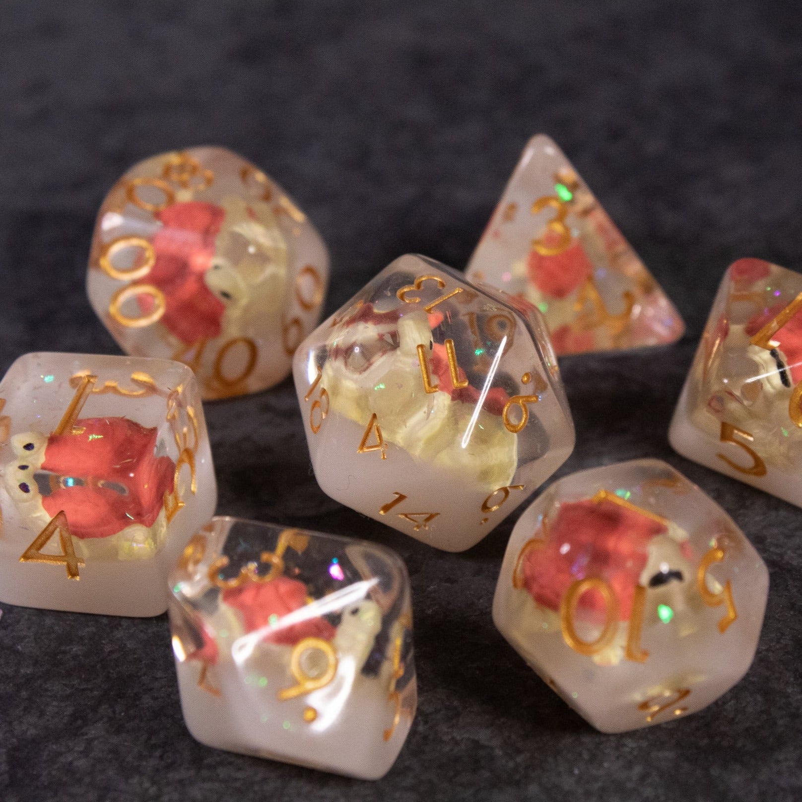 Brown Turtle Dice Set - Set of translucent brown polyhedral dice with embedded miniature red turtles and gold numbering.
