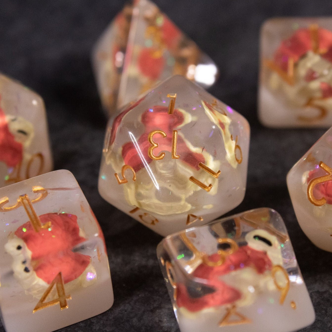 Brown Turtle Dice Set - Translucent dice set with embedded brown and red turtle figurines, gold numbers on varied shapes.