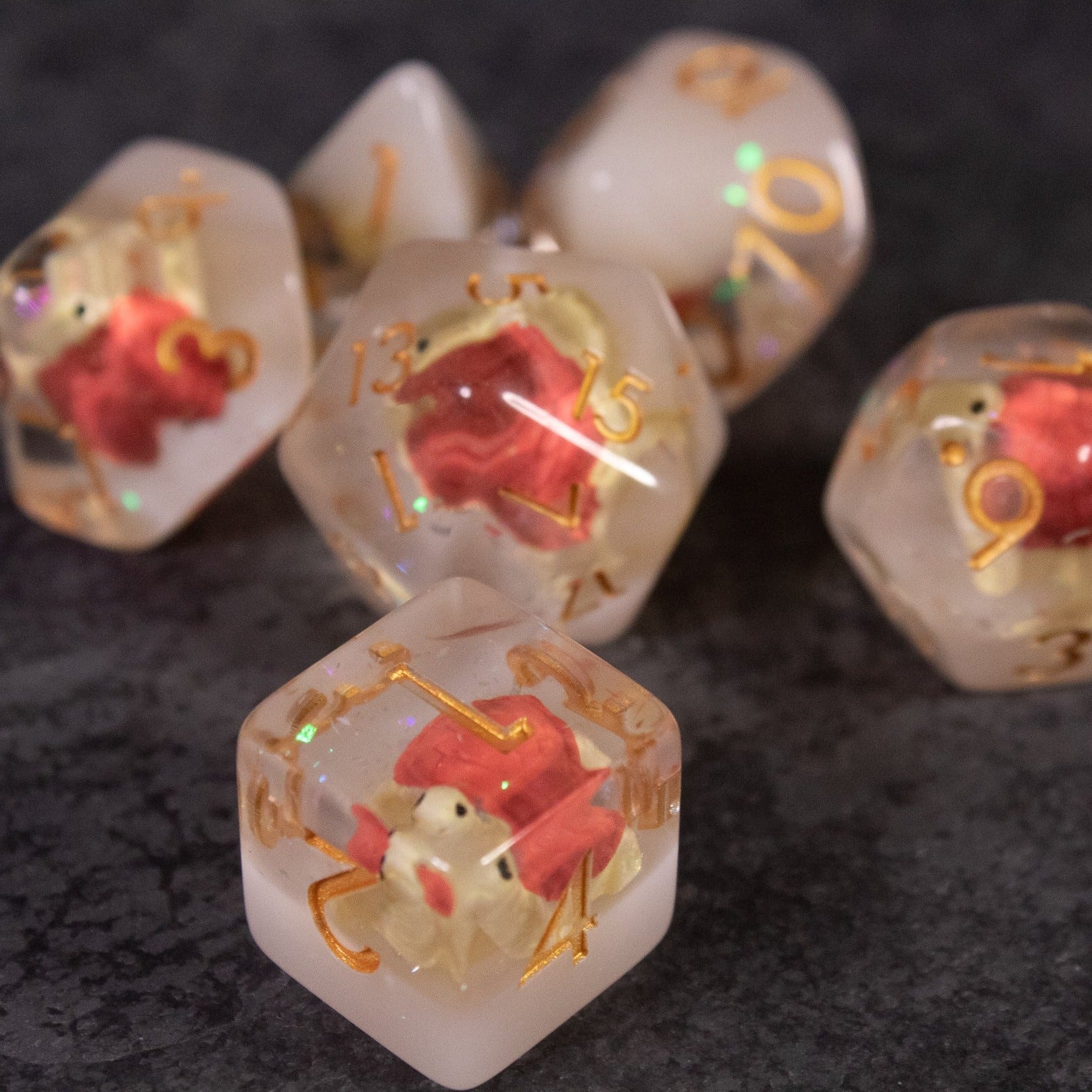 Brown Turtle Dice Set - Clear dice with embedded miniature brown turtles and gold numbering on a dark background.