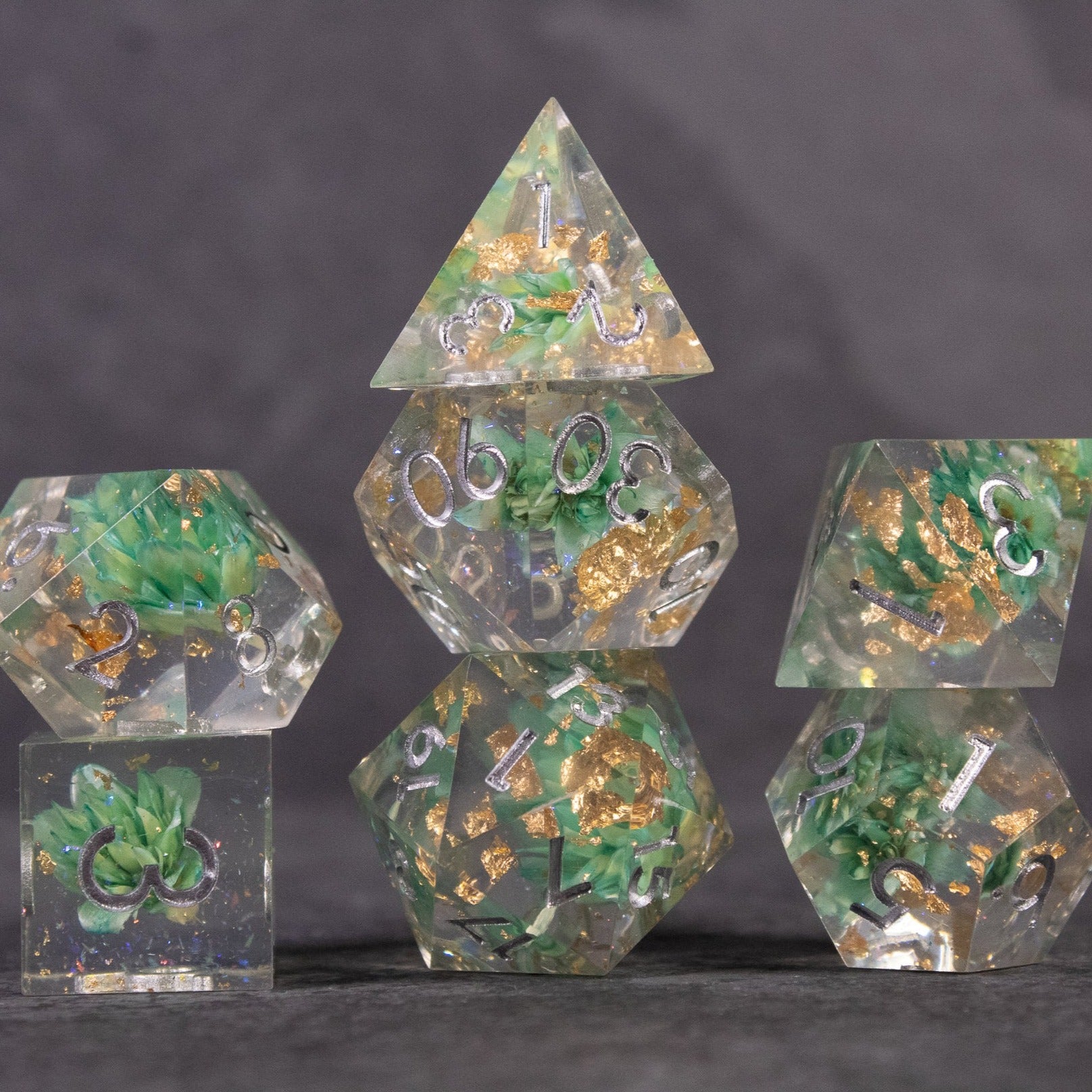 Teal Lotus Flower Dice Set - Teal and gold lotus flower-themed sharp edge polyhedral dice set with metallic numbers.