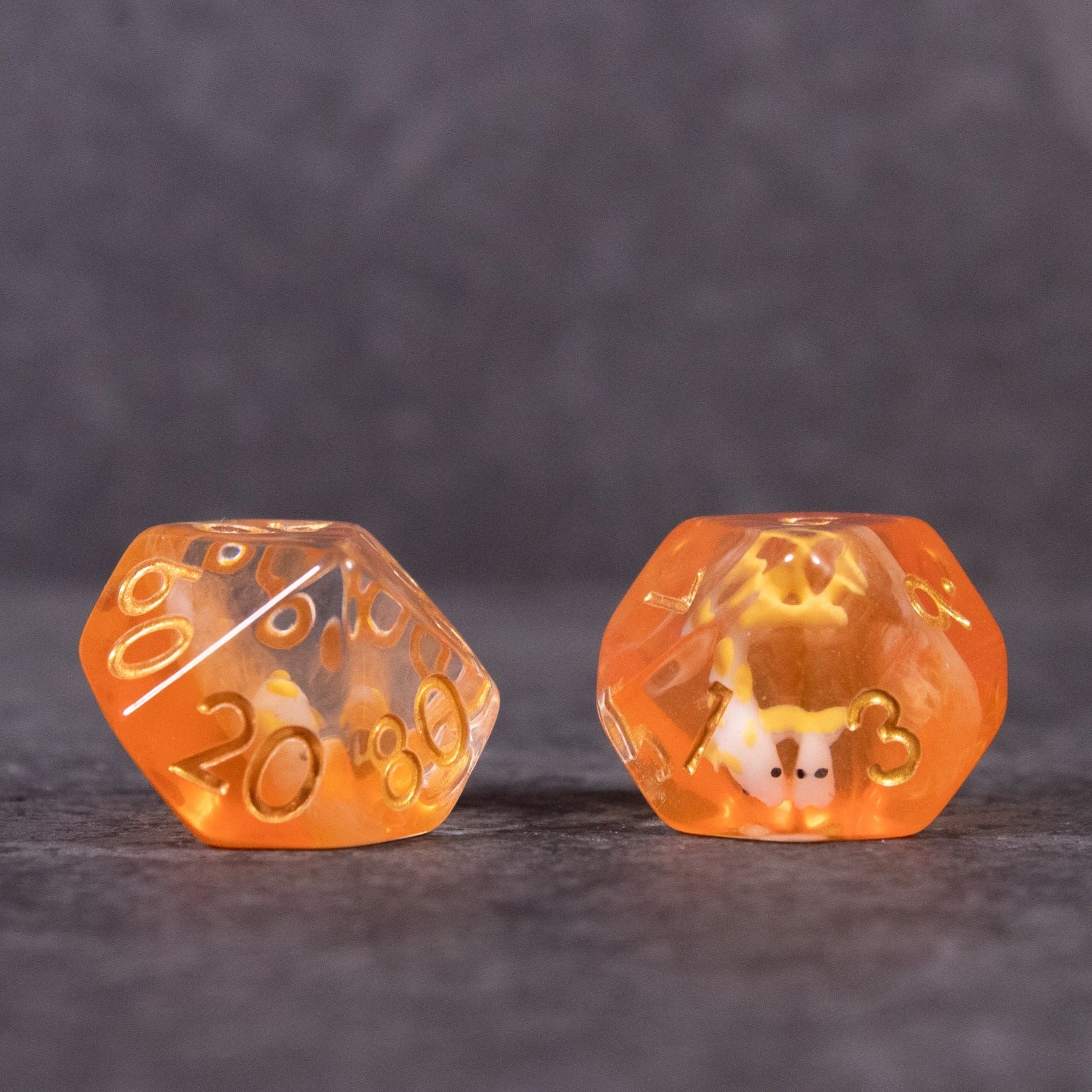 Orange Koi Fish Dice Set - Translucent orange 20-sided dice with gold numbering and koi fish design inside one die.