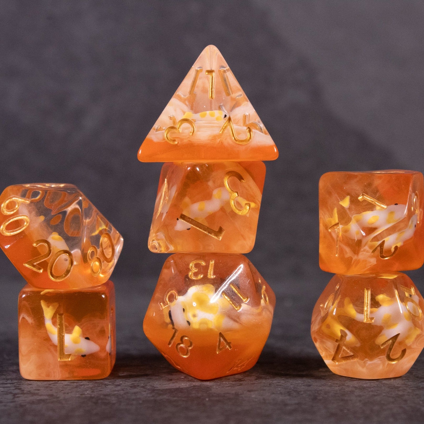 Orange Koi Fish Dice Set - Orange translucent koi fish dice set with gold numbers, featuring a miniature koi inside each die.