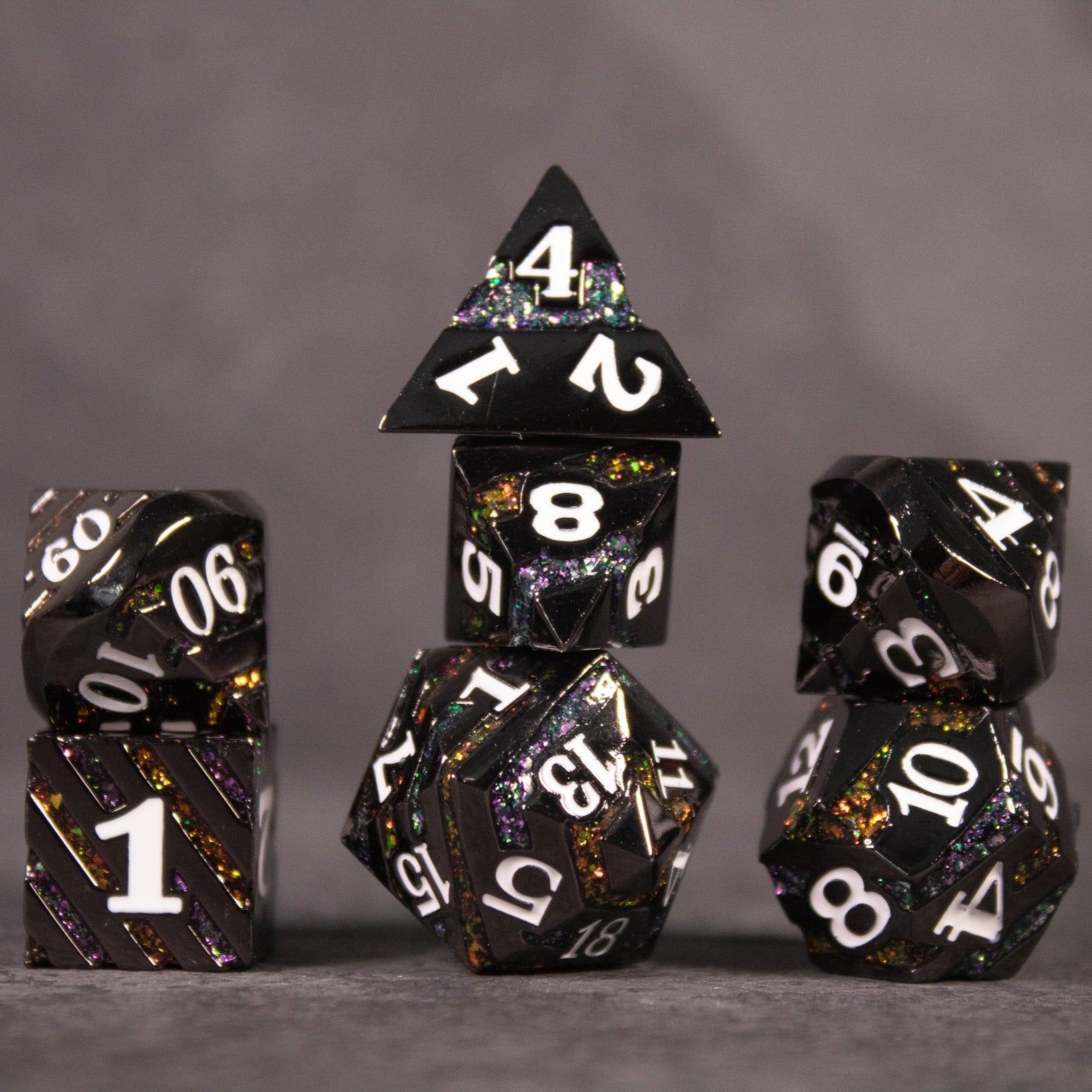 Arcane Leyline Dice Set - Orange & Pink - Black metal polyhedral dice set with colorful orange and pink flecks and white numbering.