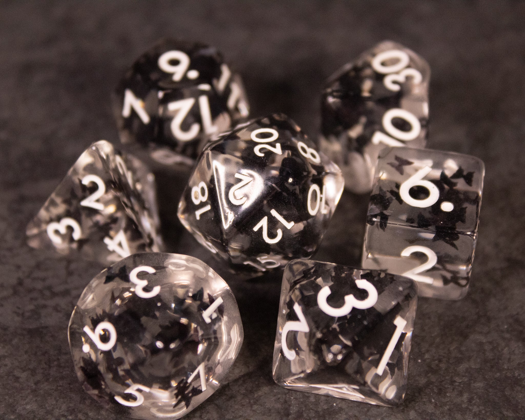 Black Butterfly Dice Set - Set of seven black translucent dice with white numbers, each containing a delicate butterfly inside.