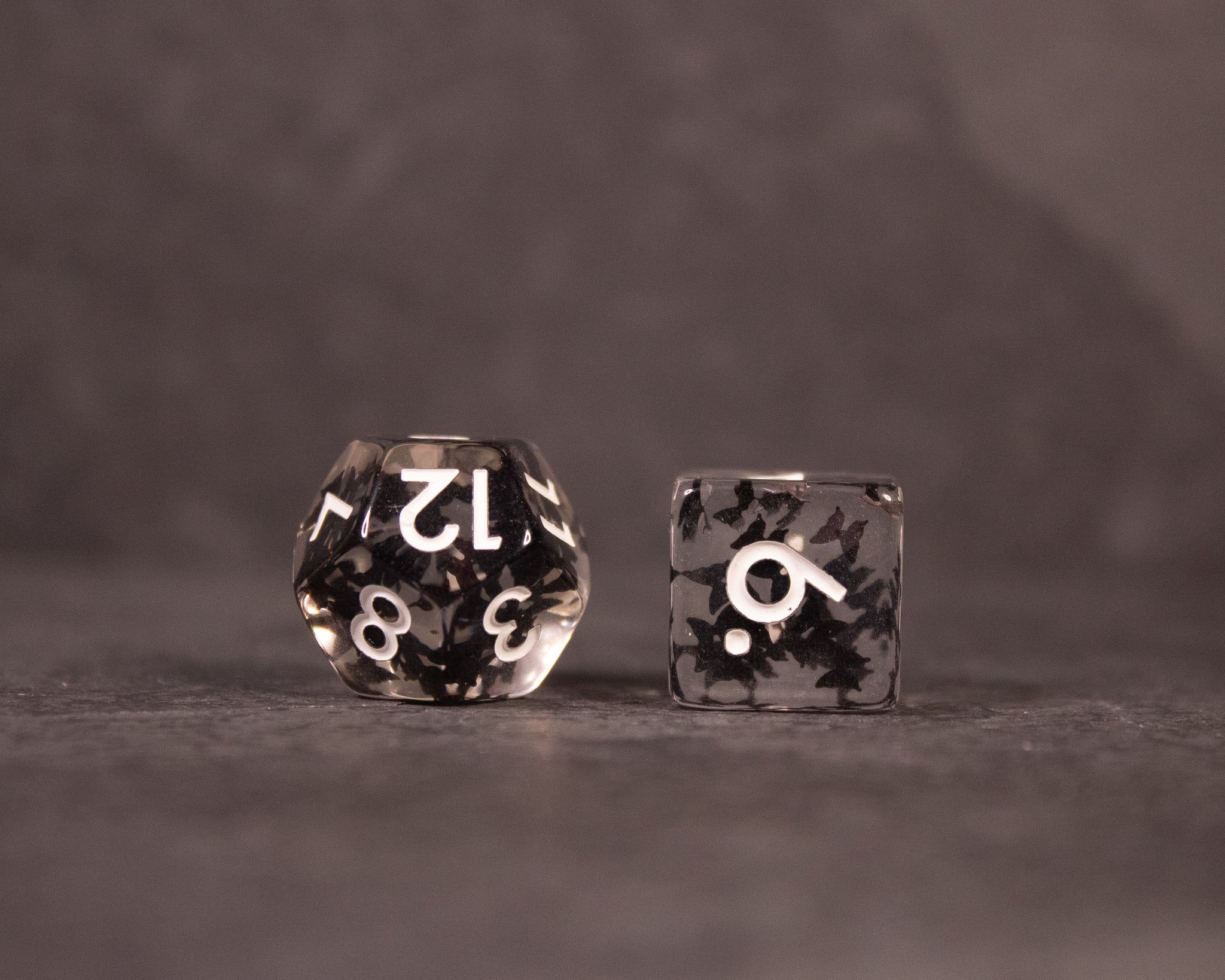 Black Butterfly Dice Set - Black translucent polyhedral dice with white numbers and black butterfly-shaped inclusions inside.