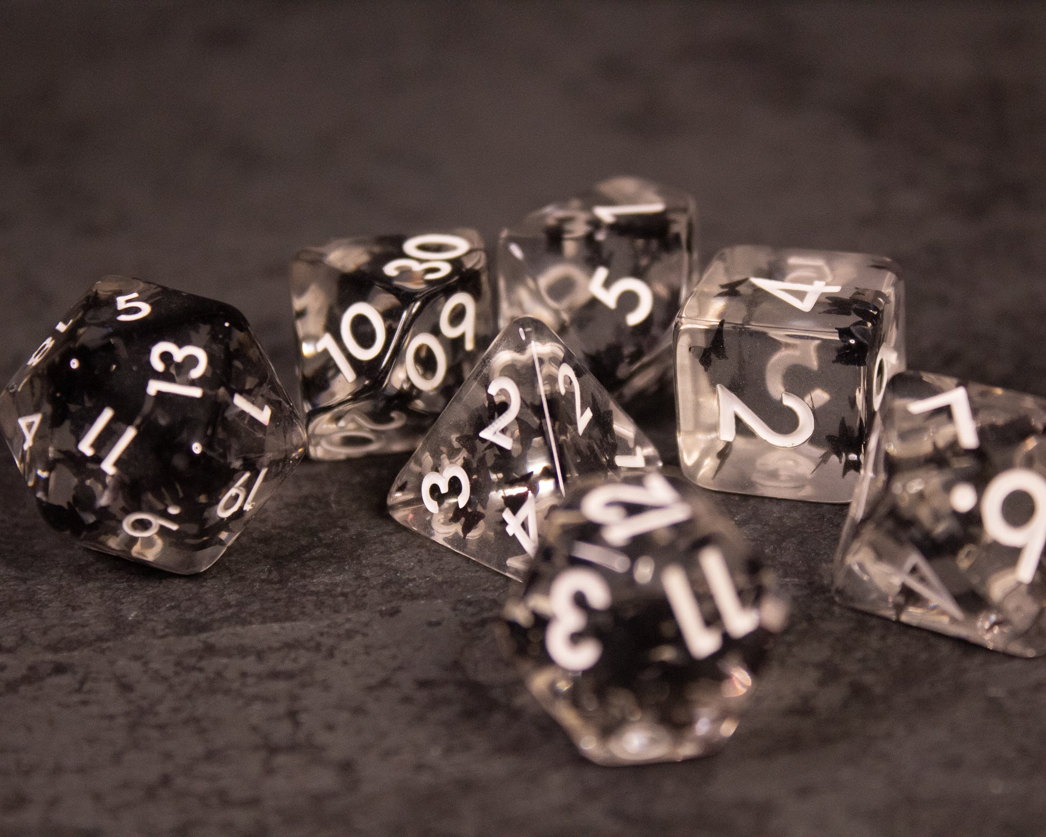 Black Butterfly Dice Set - Transparent black polyhedral dice set with white numbers, featuring butterfly design inclusions inside each die.