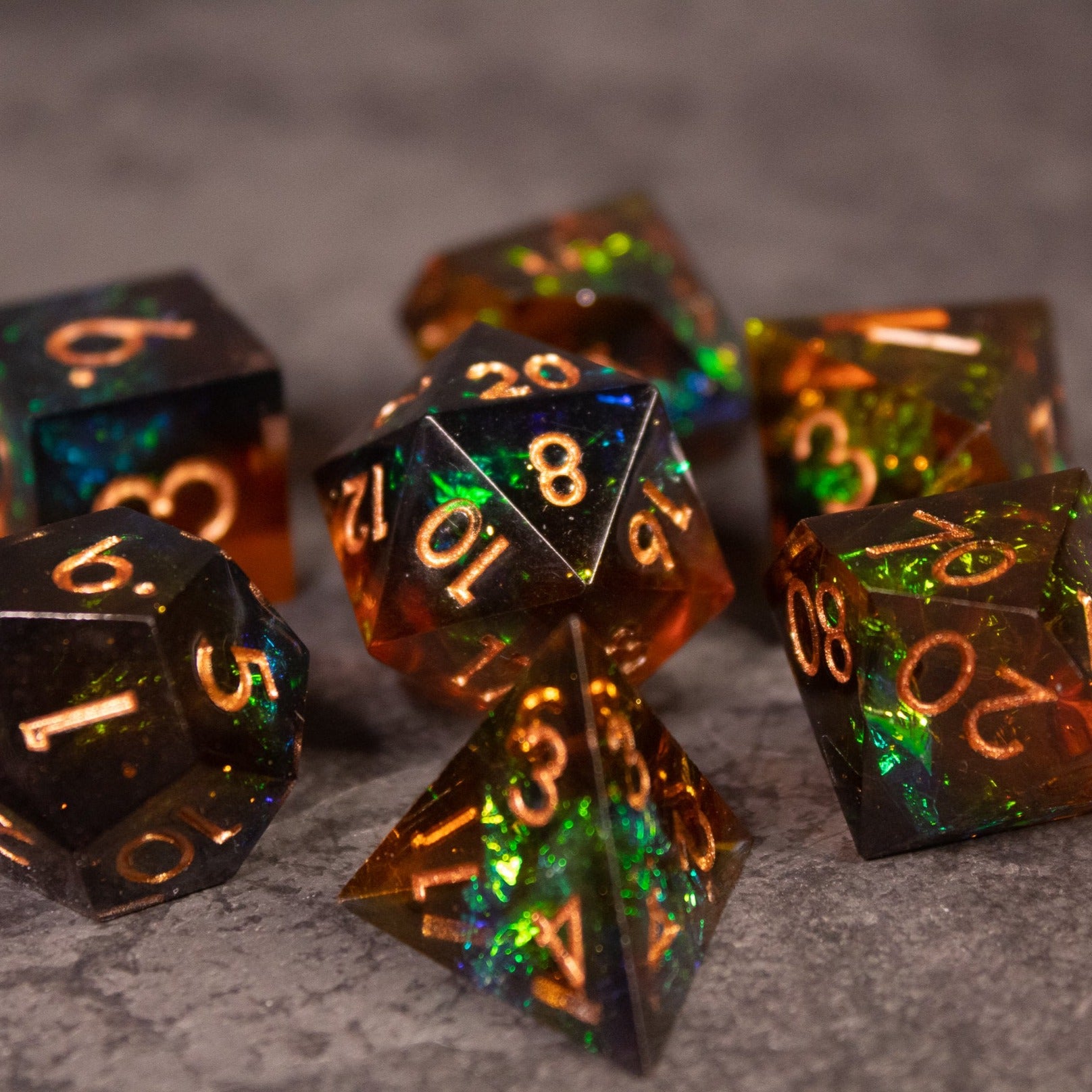 Whiskeyjack Dice Set - Sharp-edged translucent black and amber dice set with gold numbers and iridescent flecks.