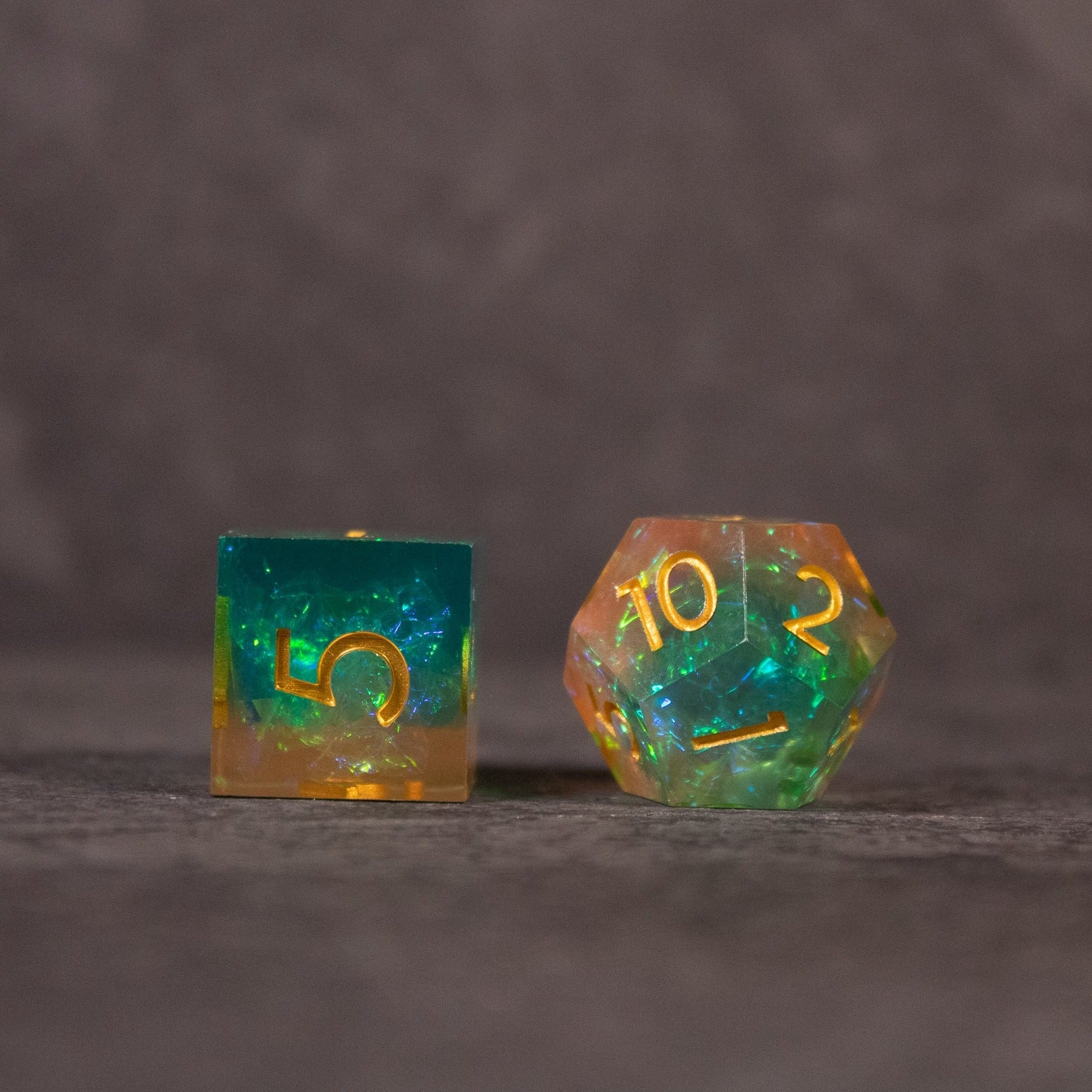 Seafarer Dice Set - Green and orange sharp-edged dice with gold numbering, including a d6 and a d20.