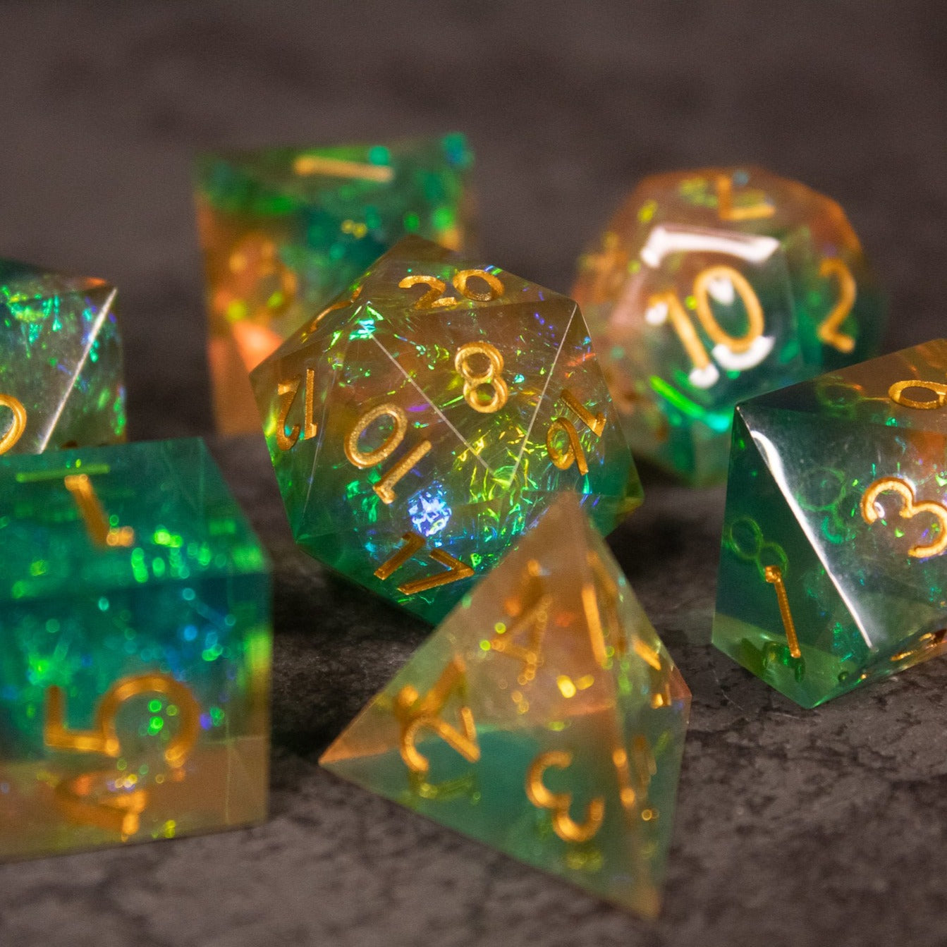 Seafarer Dice Set - Set of sharp-edged translucent dice blending green and orange with gold numbering.