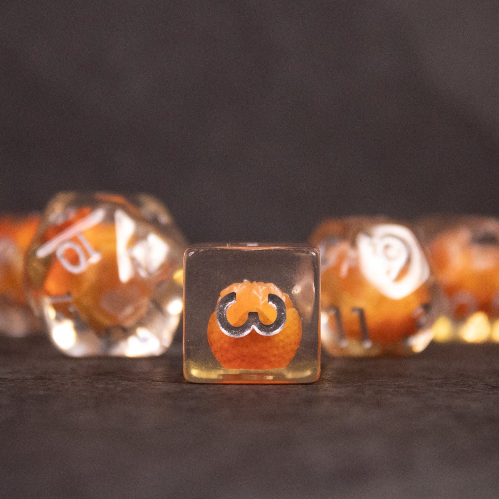 Orange Fruit Dice Set - Clear dice with orange fruit illustration inside showing various numbers and symbols.
