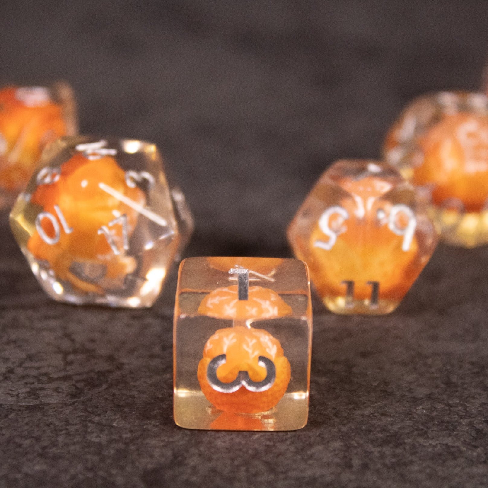 Orange Fruit Dice Set - Clear polyhedral dice set with bright orange fruit designs inside each die, white numbering.