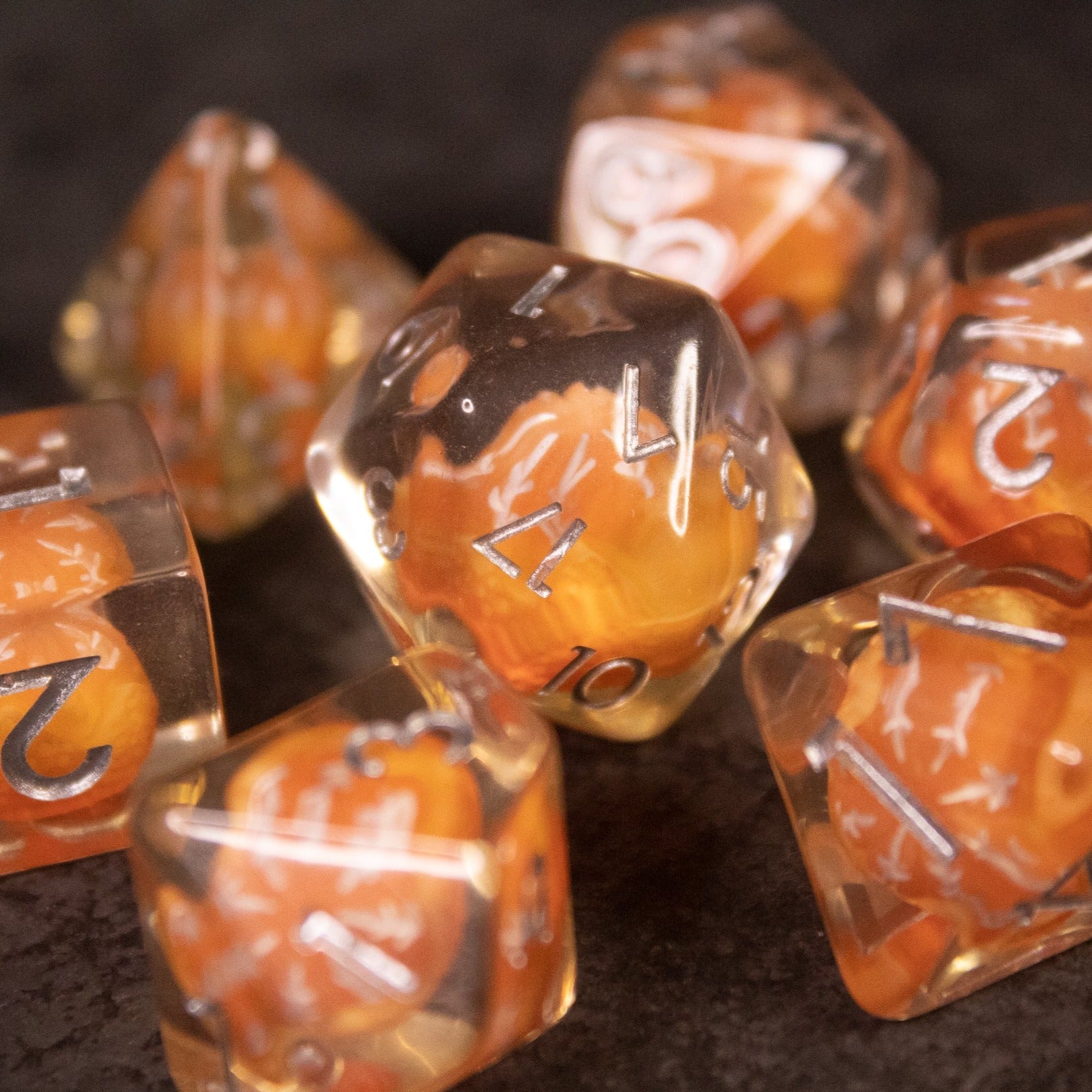 Orange Fruit Dice Set - Transparent polyhedral dice with miniature orange fruit designs inside and white numbers on the faces.