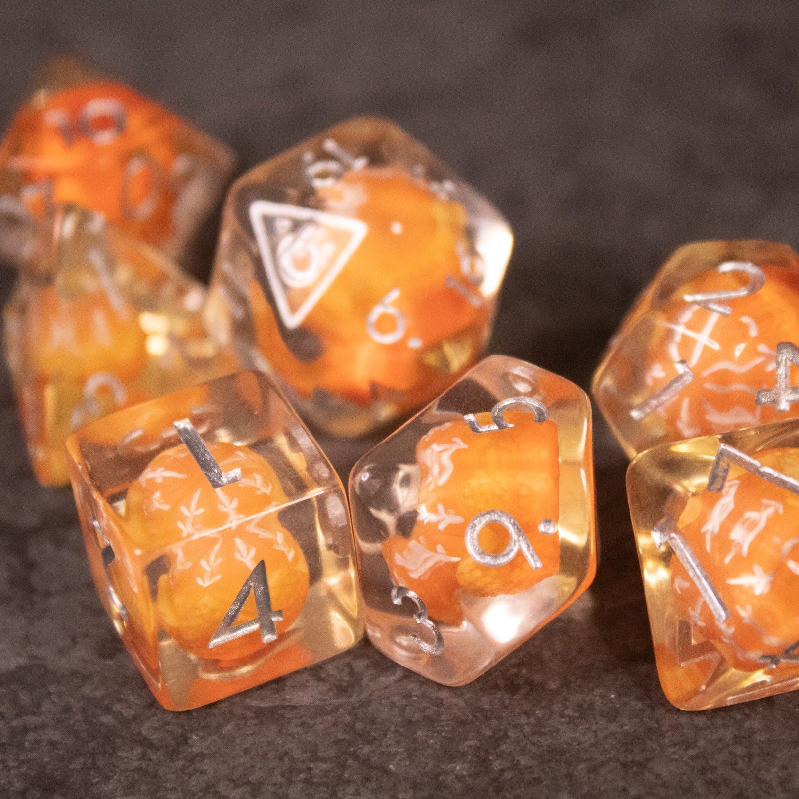 Orange Fruit Dice Set - Set of clear polyhedral dice with detailed orange fruit designs inside and white numbering.